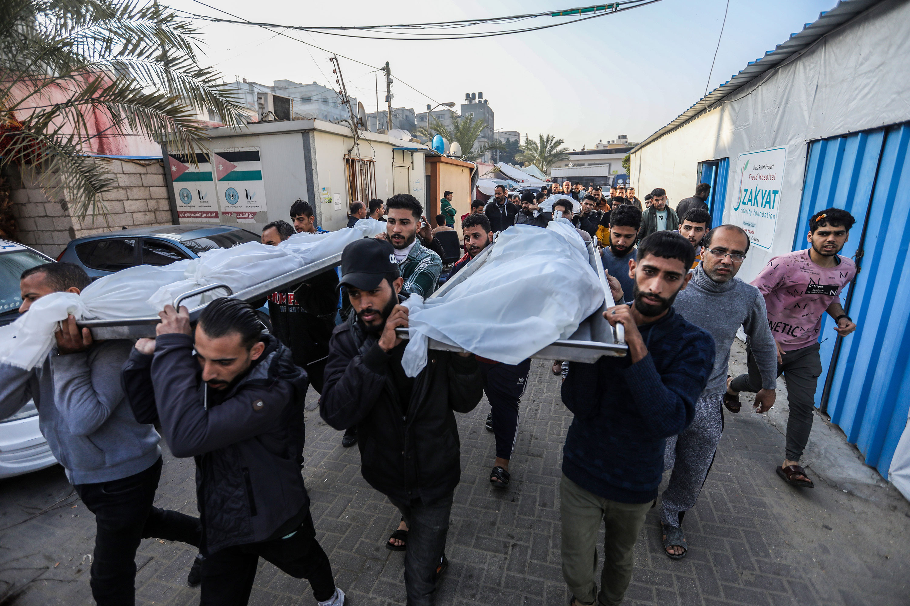 People mourn as they collect the bodies of Palestinians killed in an airstrike in Khan Younis, Gaza, on Saturday, December 2. 