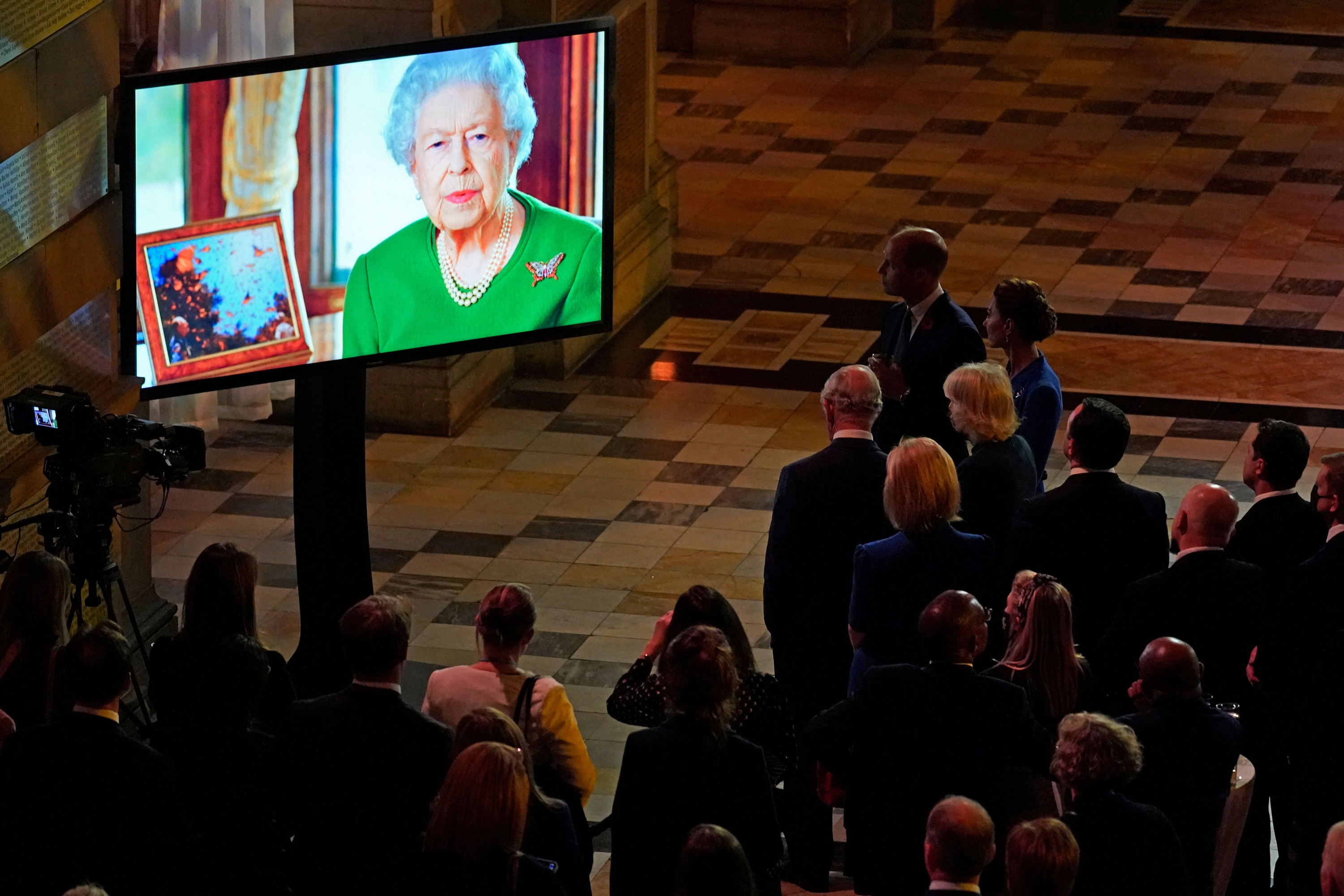 Attendees watch a video message from Britain's Queen Elizabeth II during an evening reception to mark the opening day of COP26 in Glasgow, Scotland, on November 1.