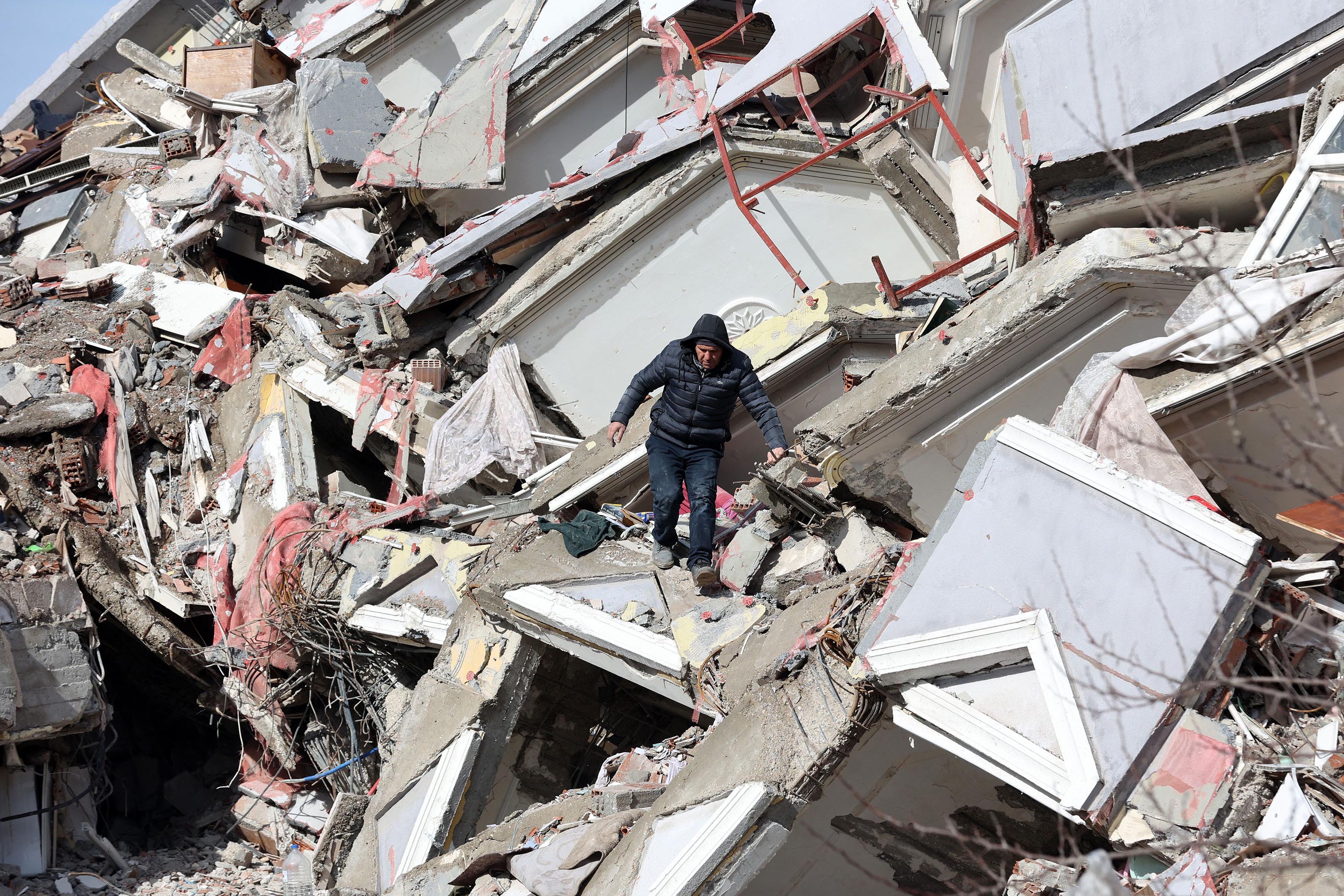 A man makes his way through the rubble of a collapsed building in Kahramanmaras, Turkey, on Tuesday, February 7.