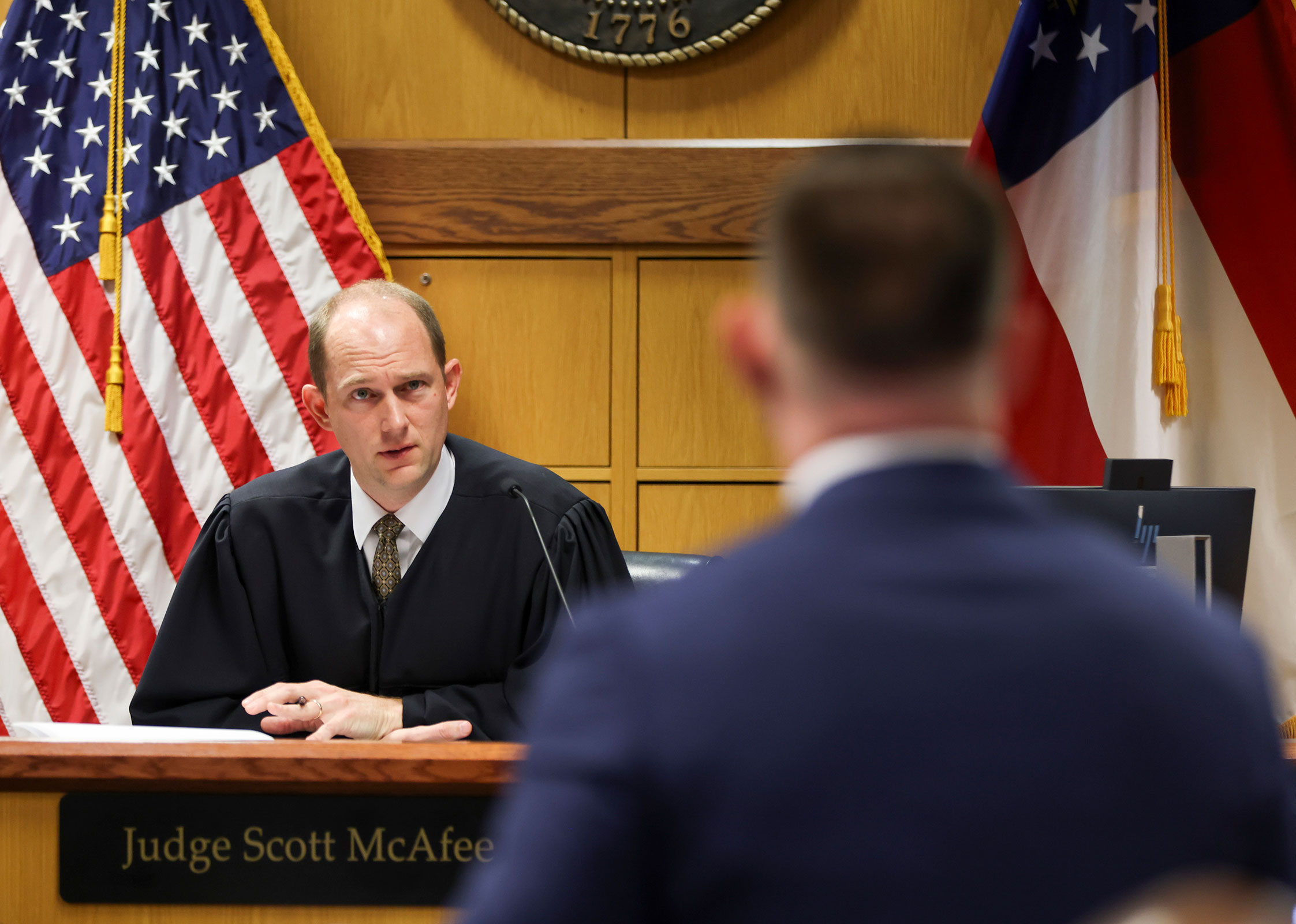 Judge Scott McAfee listens to prosecutor Will Wooten during a hearing in the case of the State of Georgia v. Donald John Trump on February 13, 2024 at the Fulton County Courthouse in Atlanta, Georgia.