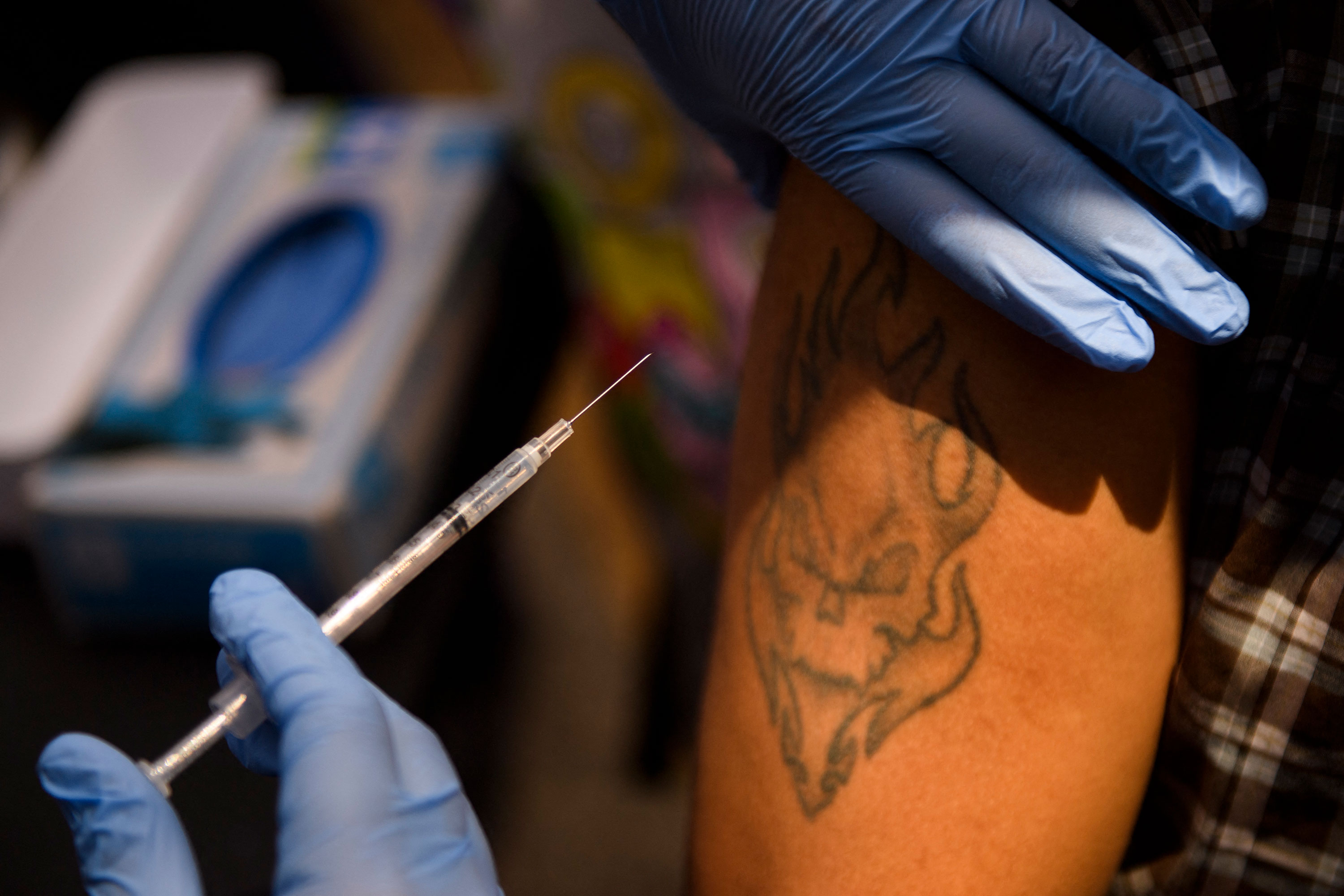 A person receives a dose of the Pfizer Covid-19 vaccine at a vaccination clinic in Los Angeles on August 7.