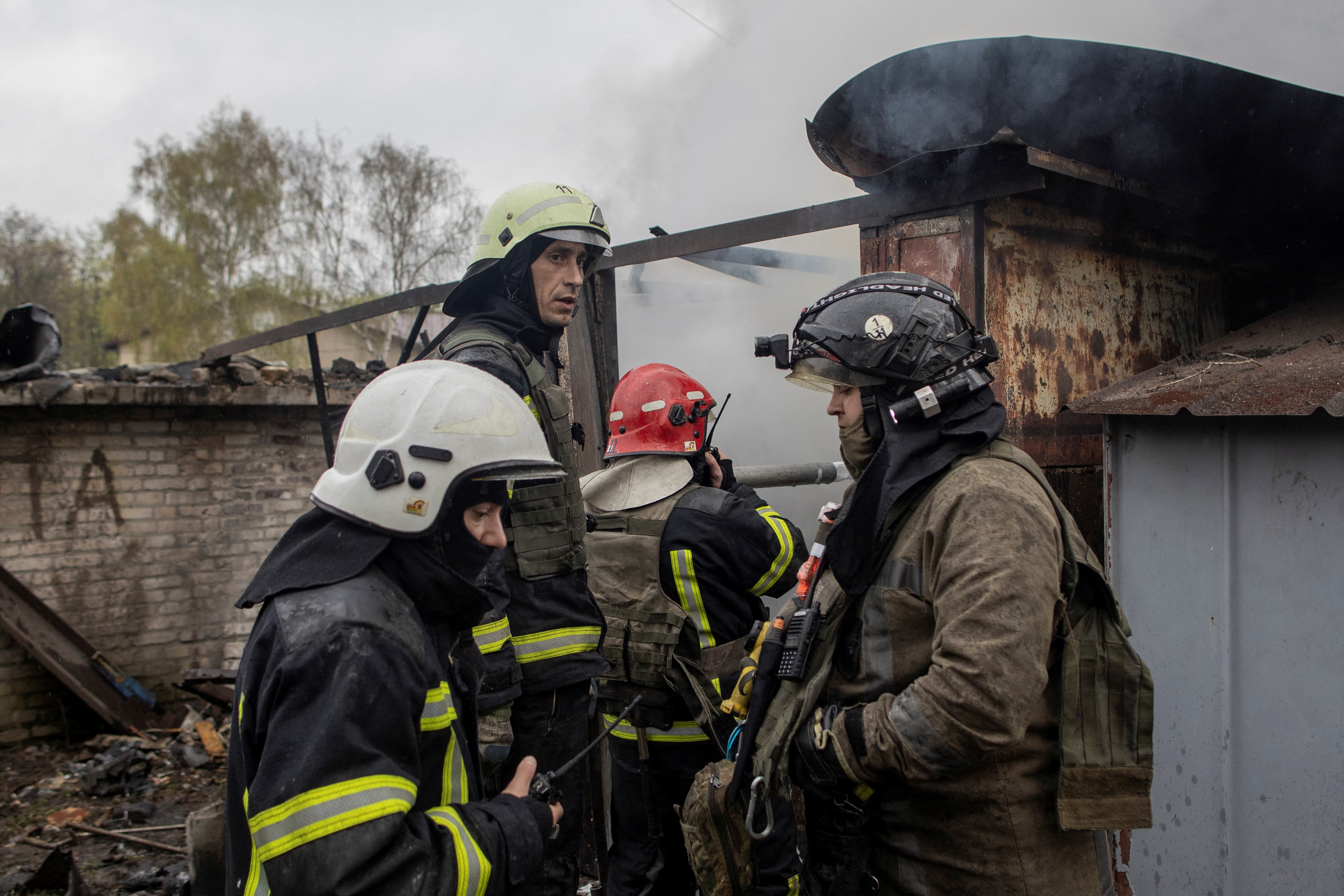 Firefighters try to extinguish a fire burning at a garage in Kharkiv, Ukraine, on April 18.