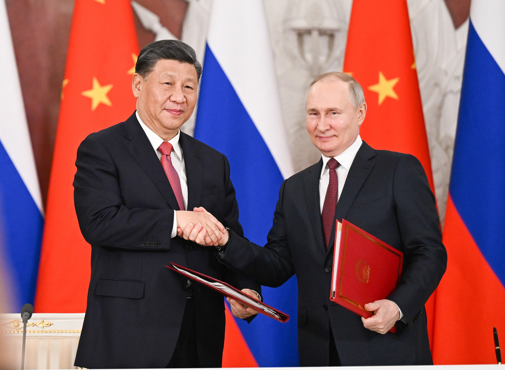 Chinese President Xi Jinping, and Russian President Vladimir Putin shake hands after jointly signing a Joint Statement of the People's Republic of China and the Russian Federation on Deepening the Comprehensive Strategic Partnership of Coordination for the New Era and a Joint Statement of the President of the People's Republic of China and the President of the Russian Federation on Pre-2030 Development Plan on Priorities in China-Russia Economic Cooperation in Moscow, Russia, March 21, 2023. Xi on Tuesday held talks with Putin at the Kremlin in Moscow. (Photo by 