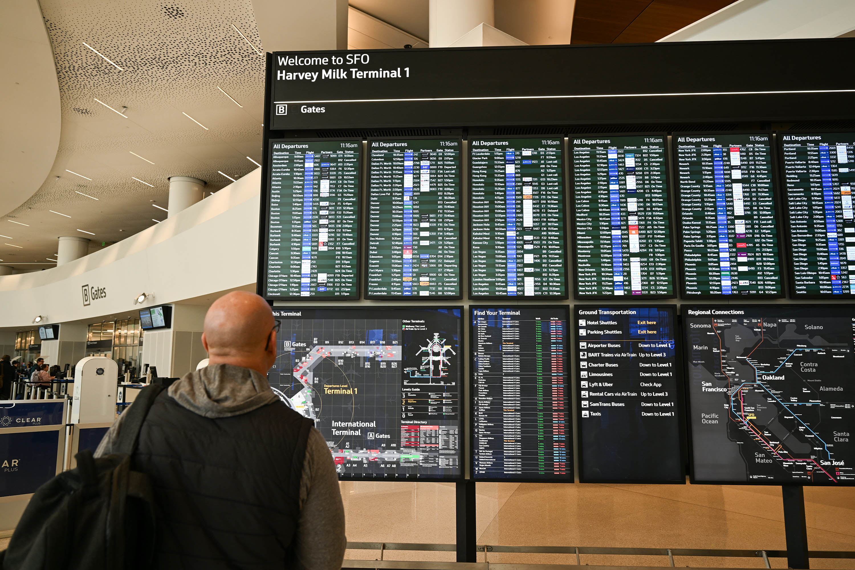 A person checks flight information signs at San Francisco International Airport on February 4. 