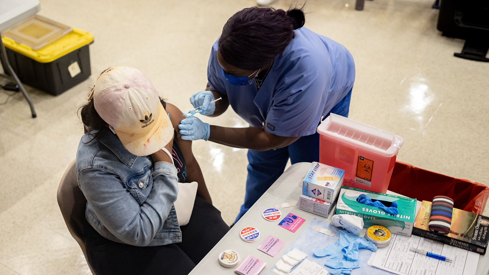 A healthcare worker administers a dose of the Pfizer-BioNTech Covid-19 vaccine at West Philadelphia High School in Philadelphia on August 4. 