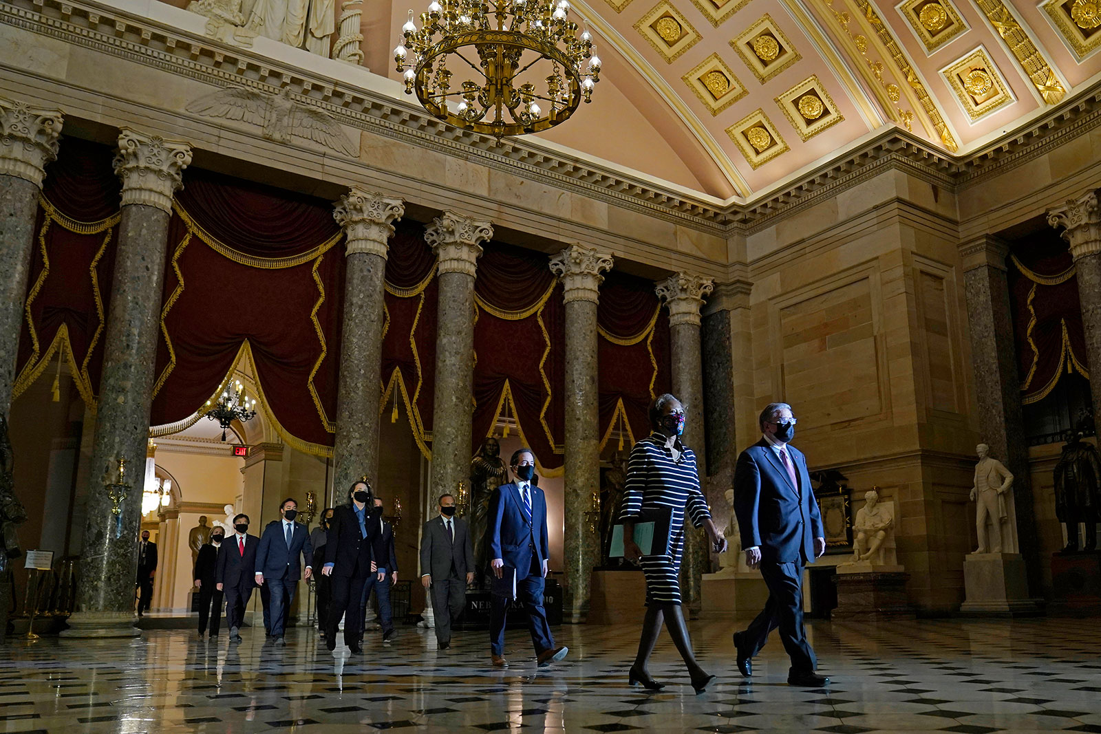 House Sergeant at Arms Tim Blodgett and House Clerk Cheryl Johnson are trailed by the House impeachment managers as they carry an article of impeachment to the US Senate on Monday, January 25.