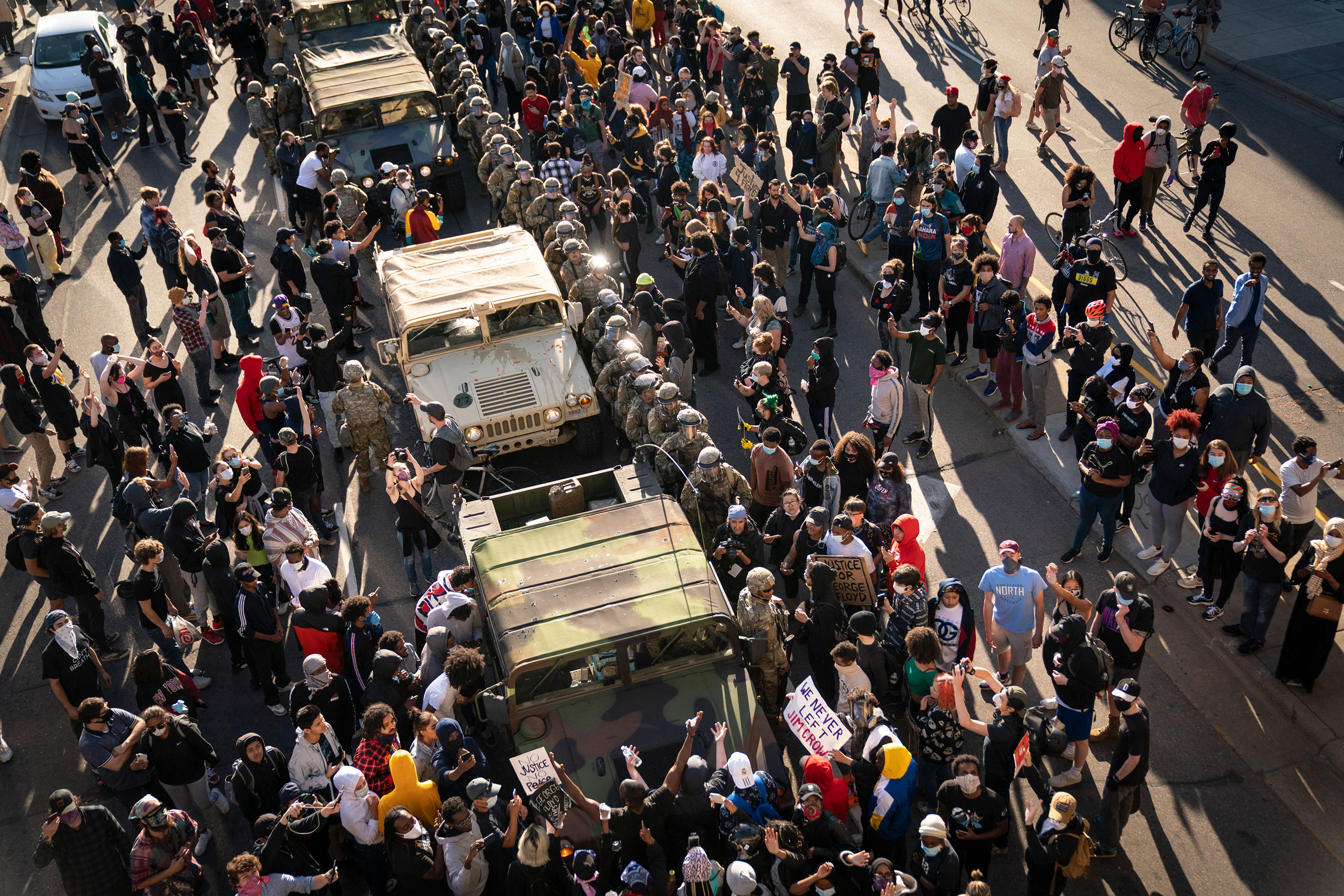 A group of protesters surround several National Guard vehicles on Lake Street in Minneapolis on May 29.