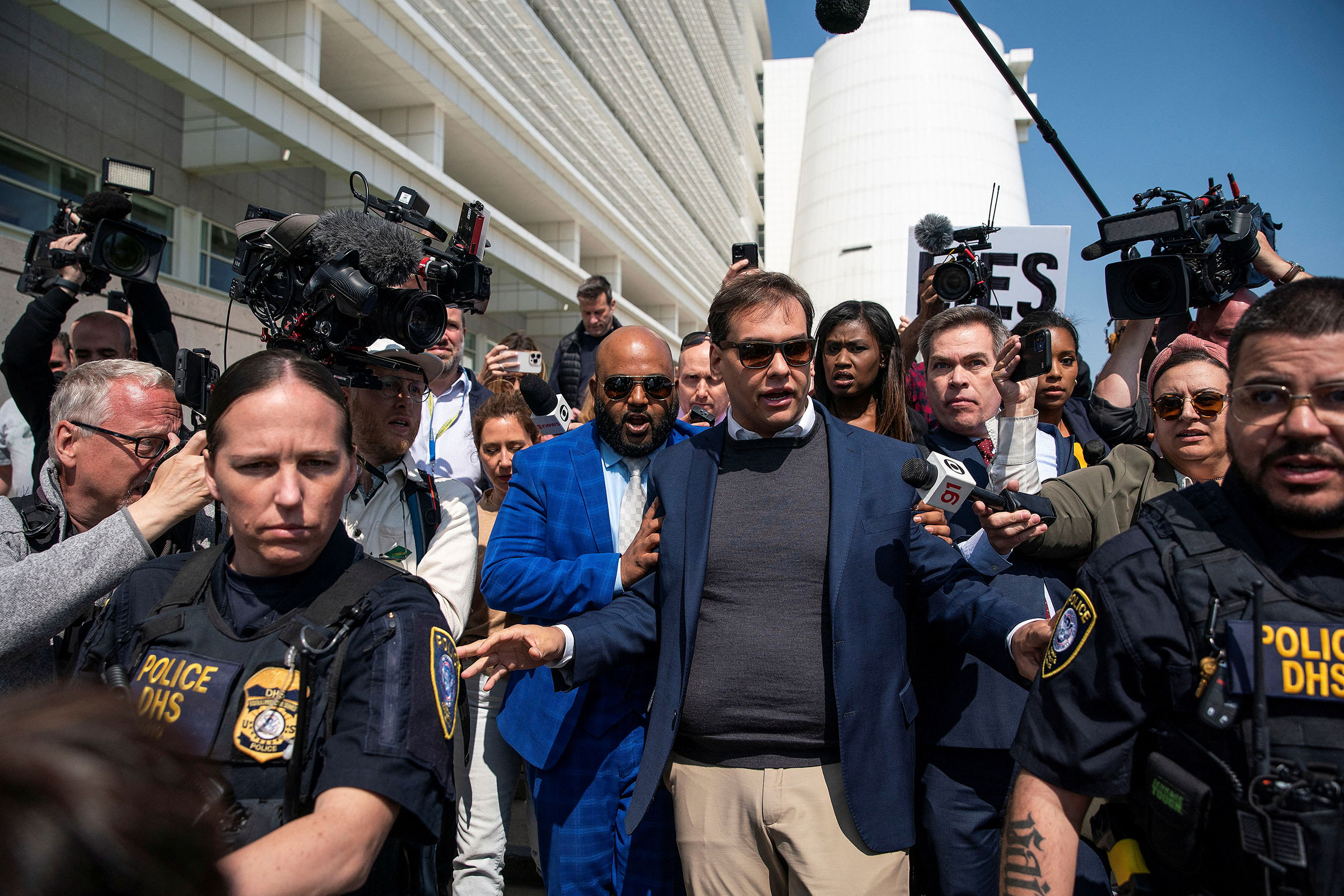 Rep. George Santos is escorted by police as he leaves Central Islip Federal Courthouse in Central Islip, New York, on May 10.