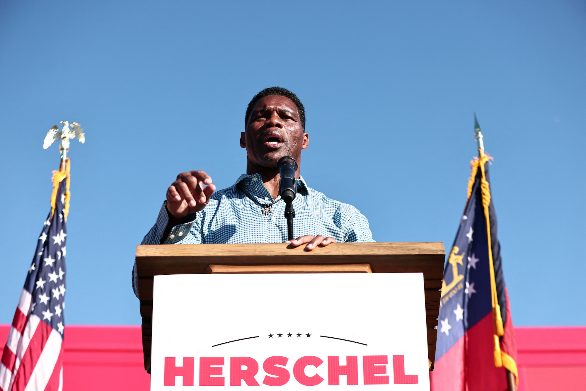 Herschel Walker gathers with supporters at a campaign stop in Newnan, Georgia on Friday.