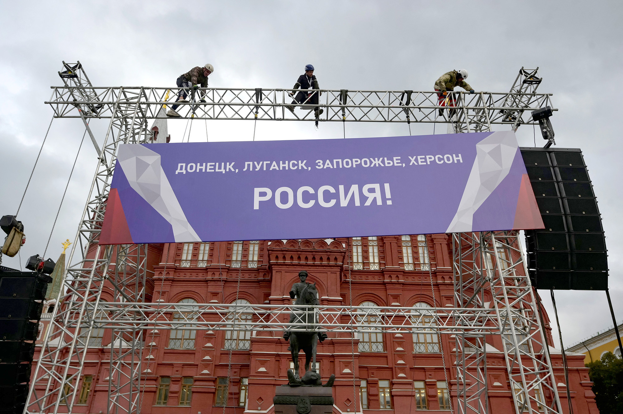 Workers fix a banner reading "Donetsk, Lugansk, Zaporizhzhia, Kherson - Russia!" on top of a construction installed in front of the State Historical Museum outside Red Square in central Moscow, Russia, on September 29.