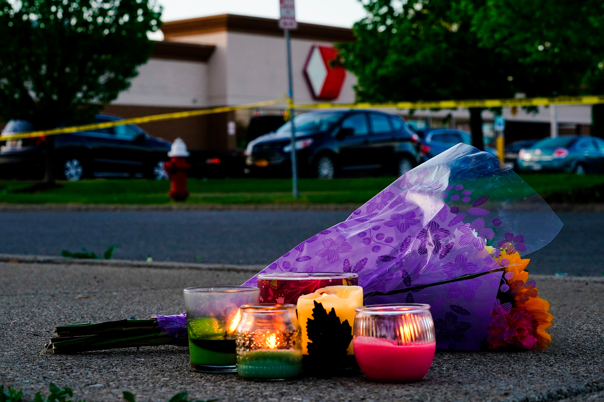 Flowers and candles lay outside the scene of a shooting at a supermarket in Buffalo, New York, on Sunday, May 15. 