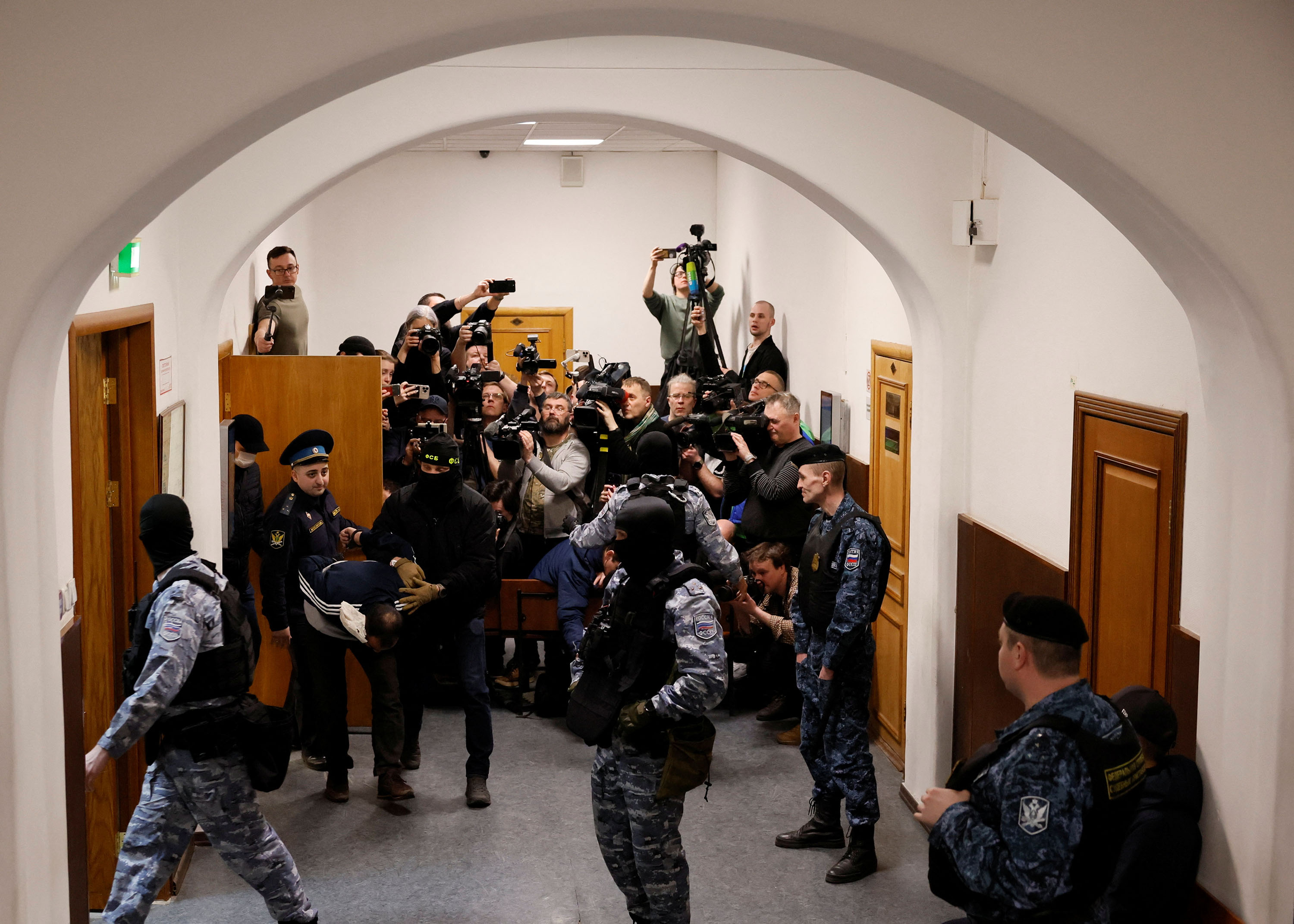 Saidakrami Murodali Rachabalizoda, a suspect in the shooting attack at the Crocus City Hall concert venue, is escorted following a court hearing at the Basmanny district court in Moscow, Russia, on March 24. 