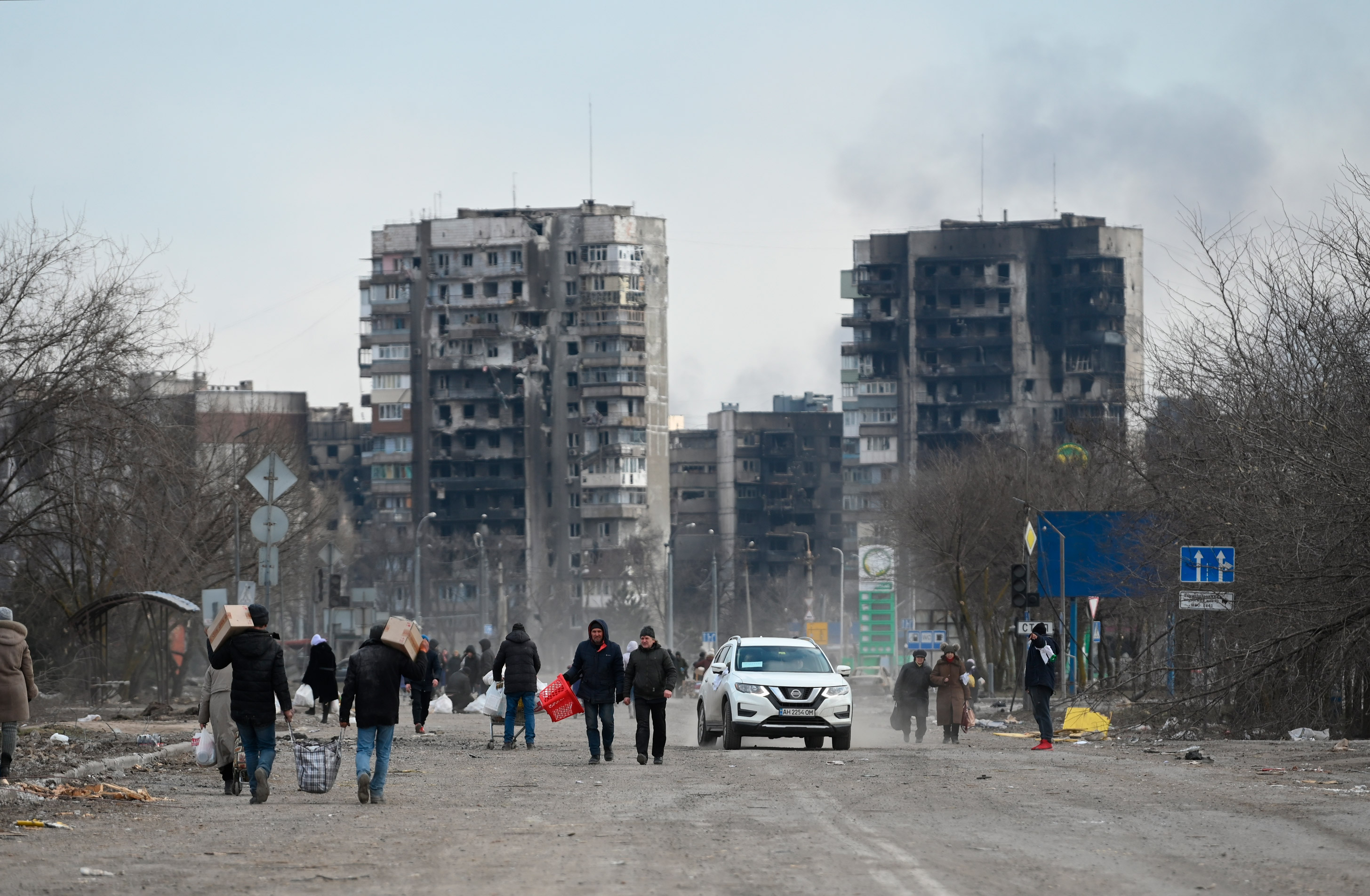 Residents carry their belongings as they leave Mariupol, Ukraine on March 16. 