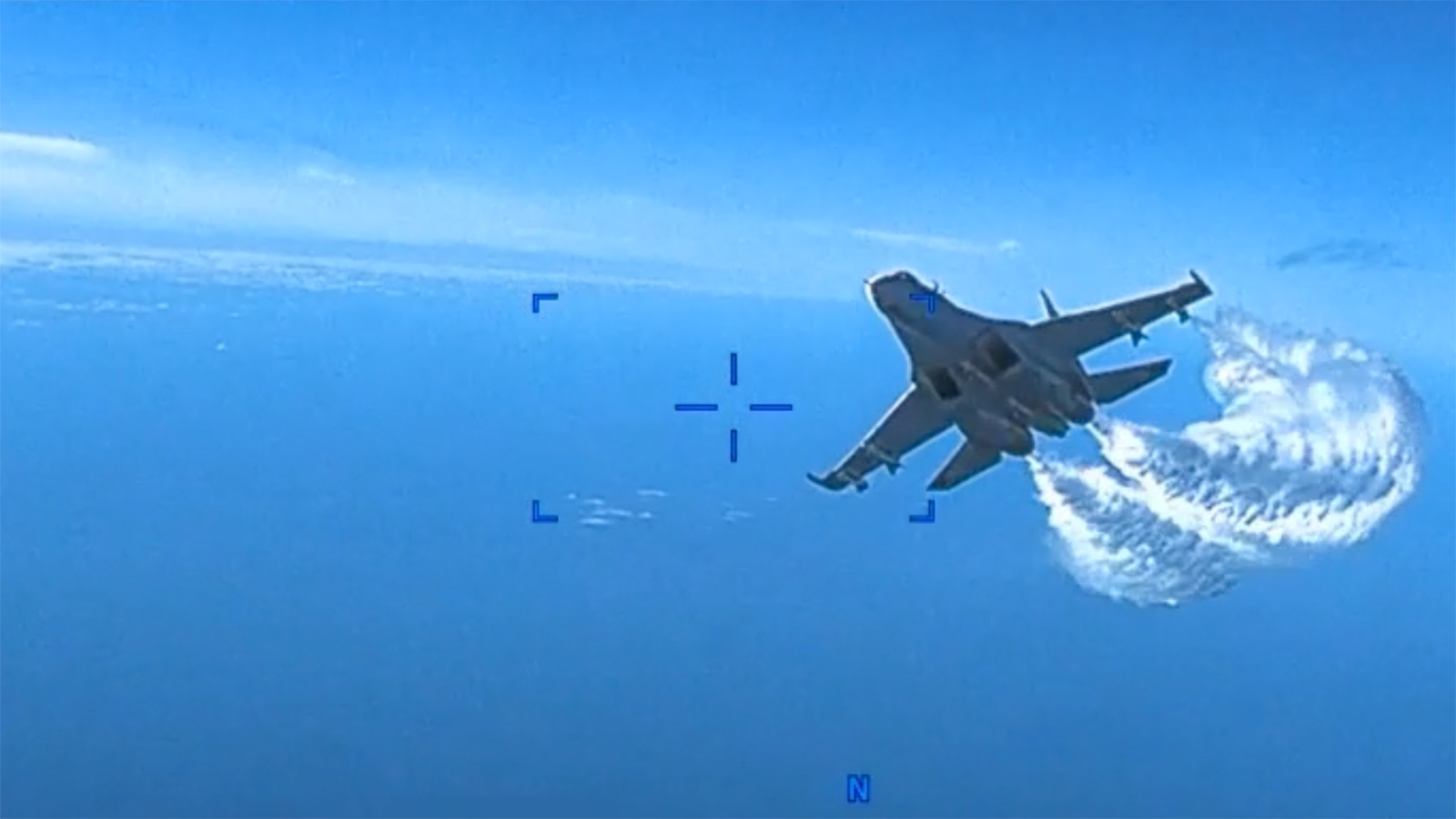 In this screengrab from video, a Russian Su-27 approaches to the rear of the U.S. Air Force MQ-9.