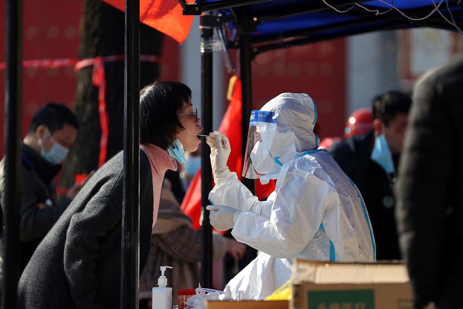 A medical worker takes a sample from a resident to be tested for Covid-19 in Xi'an, in China's northern Shaanxi province on December 21.