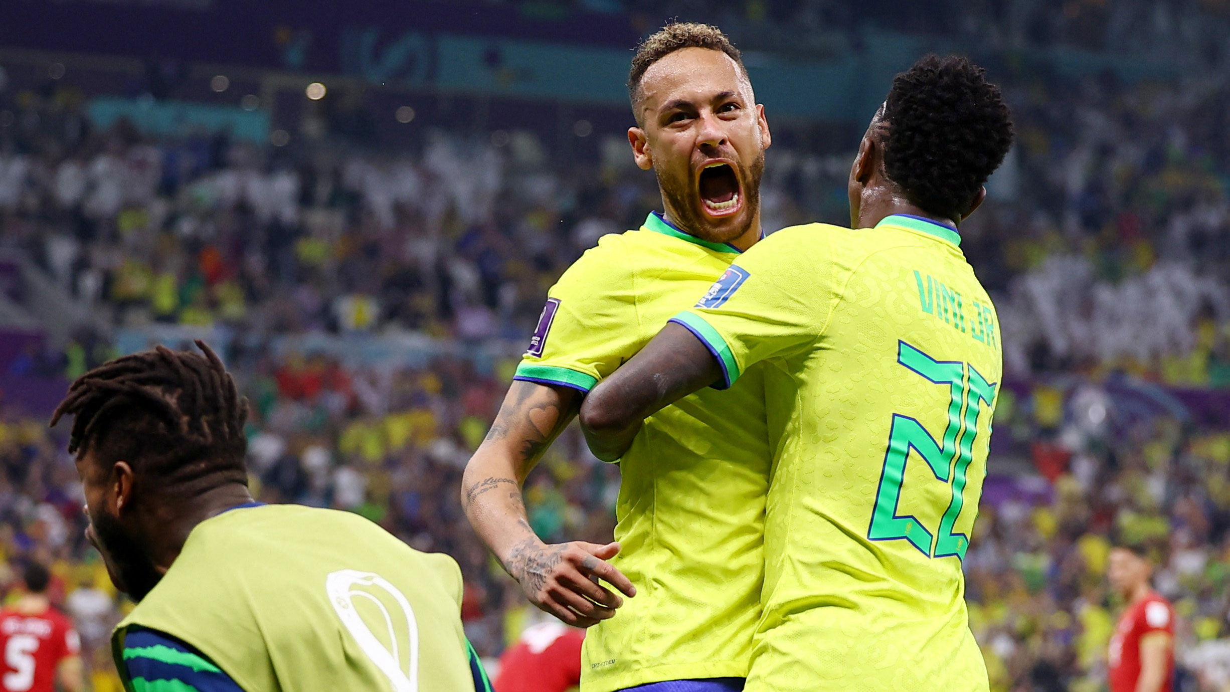 Neymar celebrates Brazil's first goal, which he helped create.