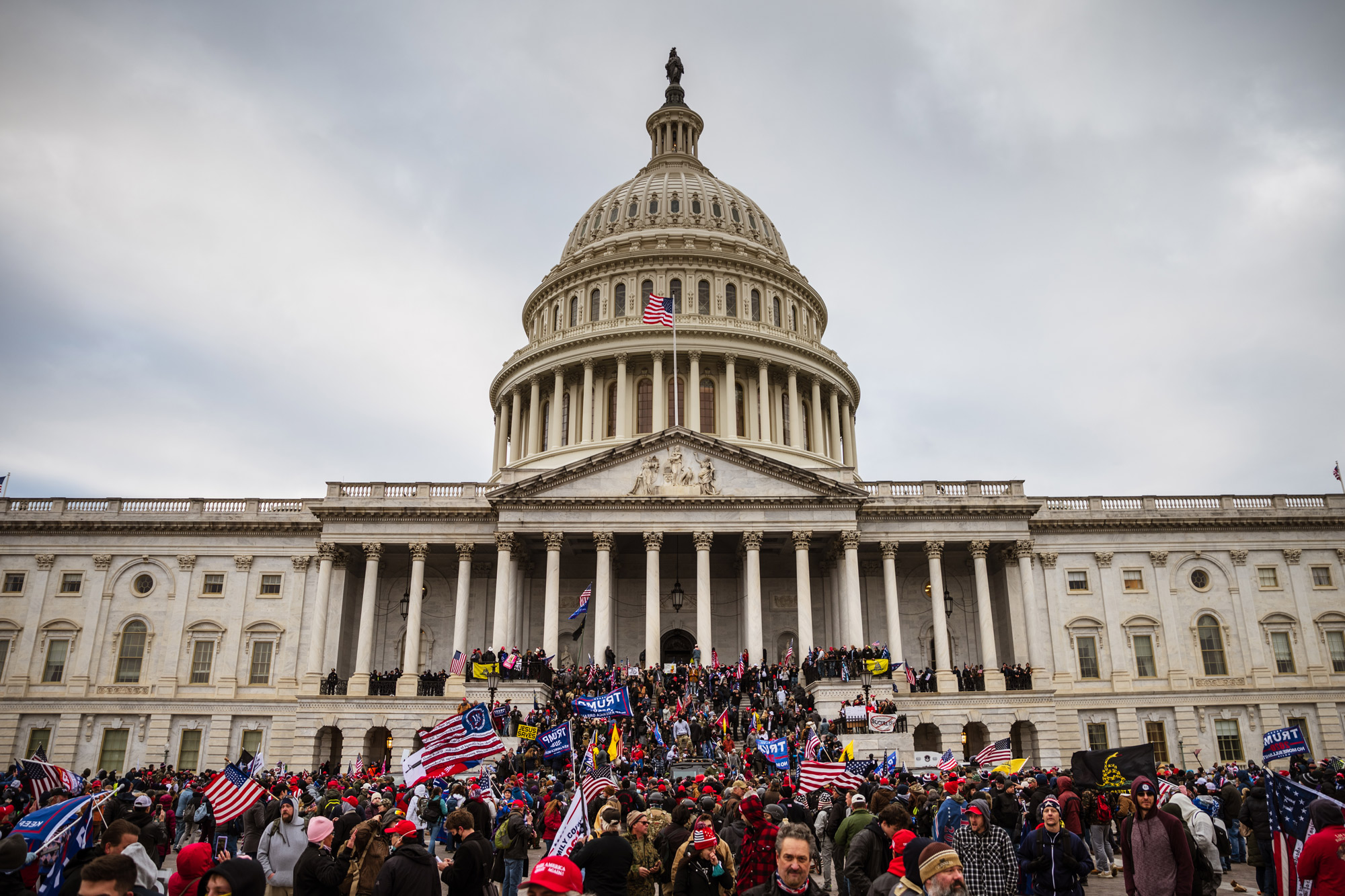 A large group of pro-Trump protesters stand on the East steps of the Capitol Building after storming its grounds on January 6 in Washington, DC. 