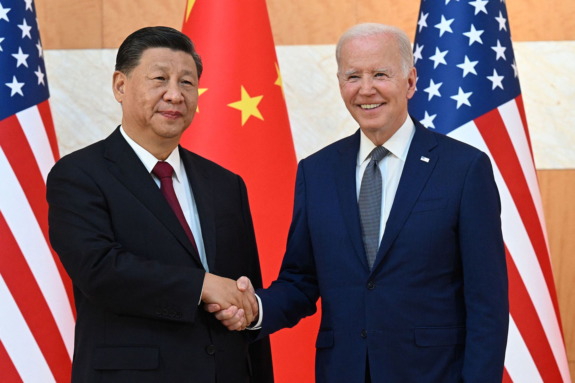 US President Joe Biden, right, and China's President Xi Jinping shake hands as they meet on the sidelines of the G20 Summit in Nusa Dua on the Indonesian resort island of Bali on November 14, 2022.