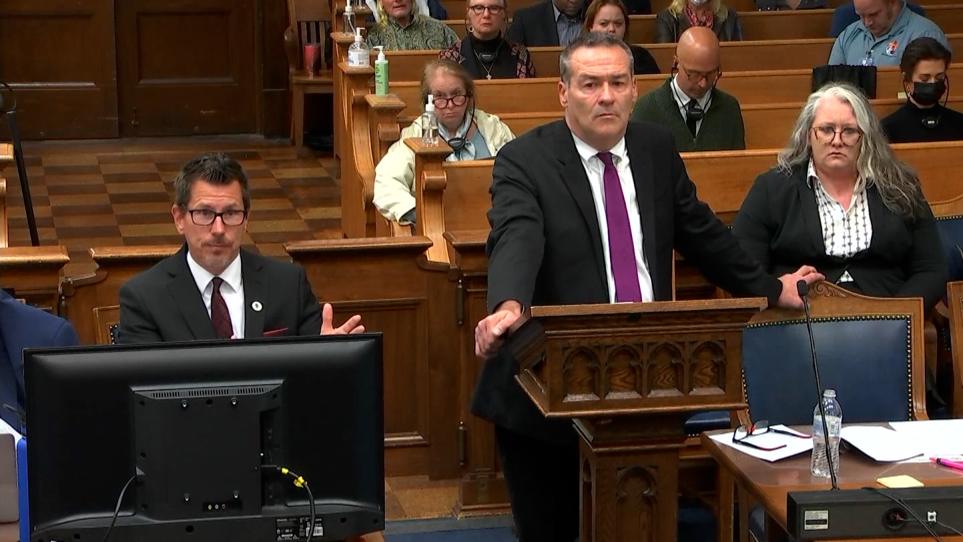 Kenosha County Assistant District Attorney Thomas Binger, sitting left, speaks to Judge Bruce Schroeder.