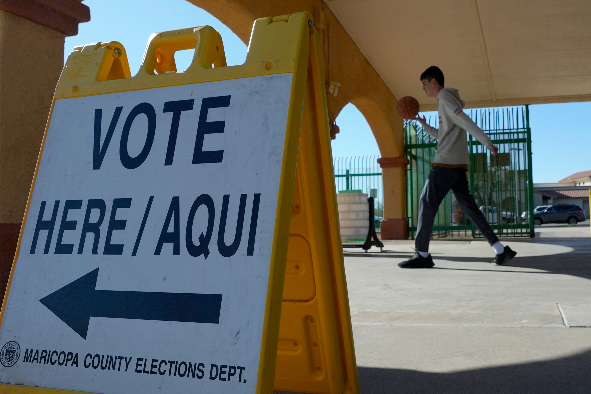 A sign points voters to a polling location as Arizonans cast their ballot on primary election day on Tuesday in Guadalupe, Arizona.