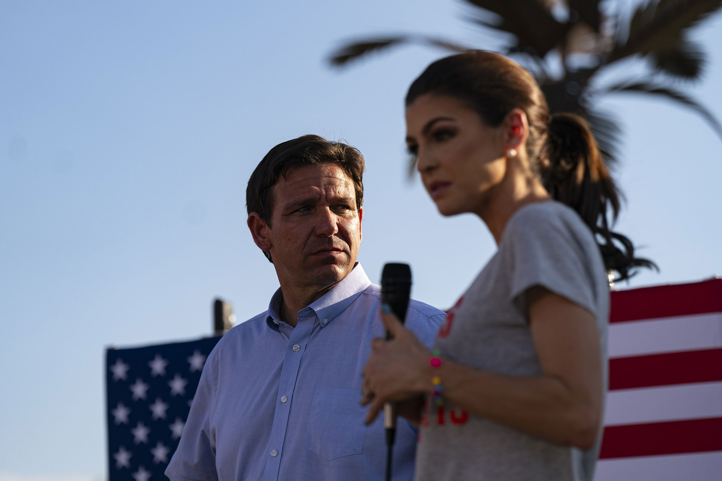 Florida Gov. Ron DeSantis listens as his wife Casey speaks during a campaign event in Panora, Iowa, on August 11.