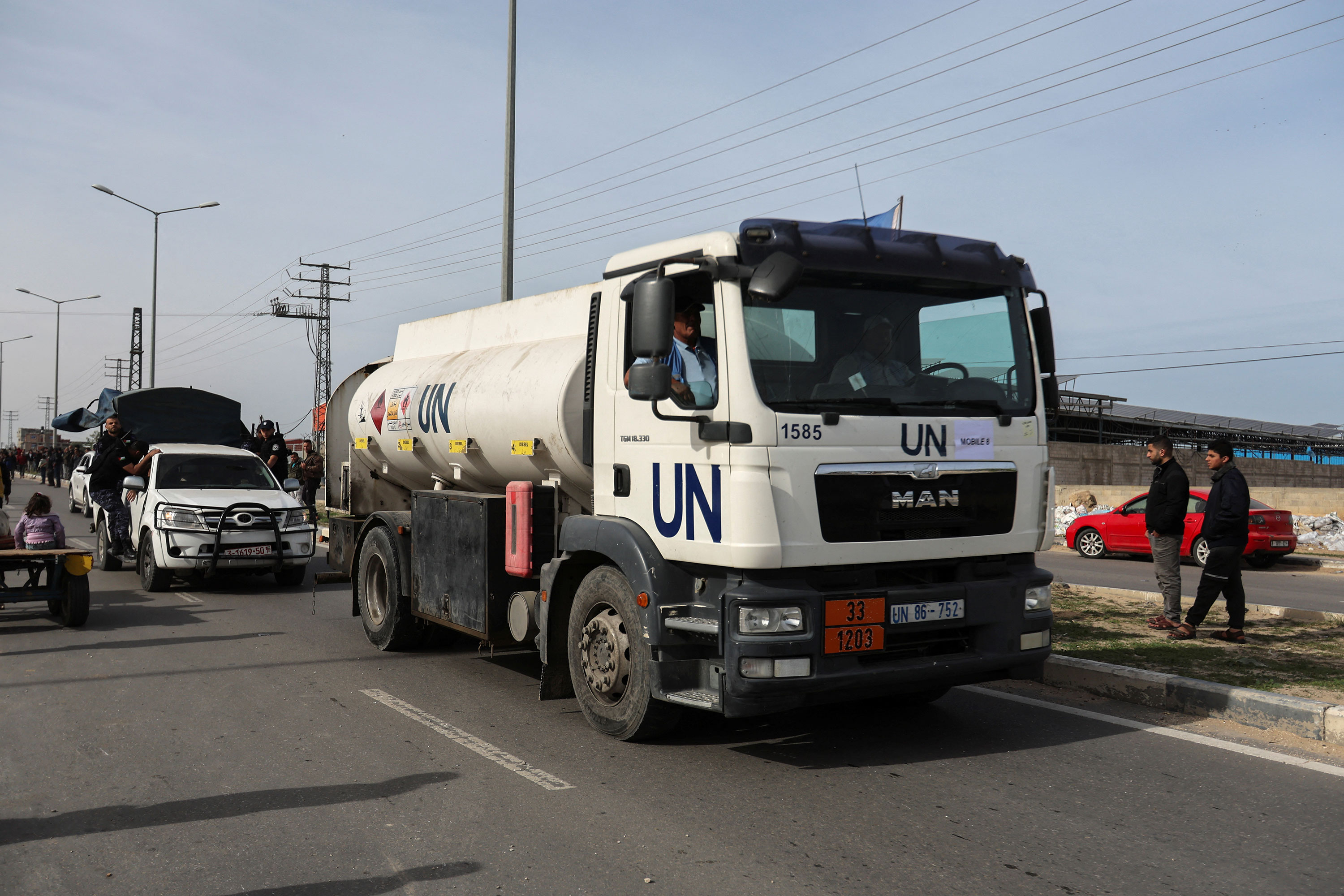 Aid trucks drive down a road in Rafah, Gaza, on Saturday. 