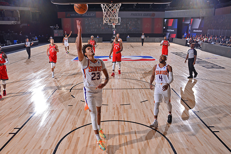  Cameron Johnson of the Phoenix Suns drives to the basket against the Toronto Raptors during a scrimmage on July 28, at The Arena at ESPN Wide World of Sports in Orlando, Florida.