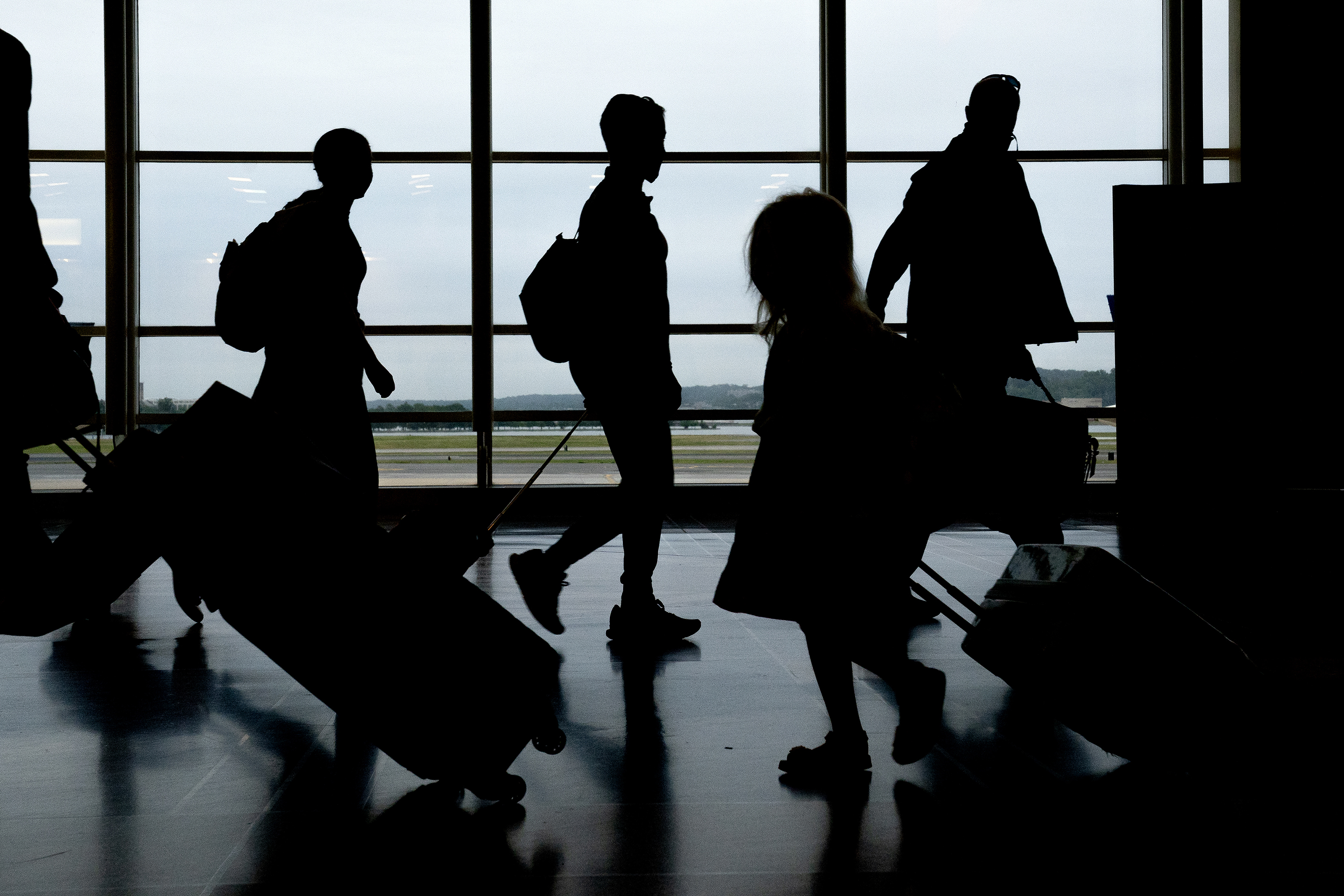 Travelers walk through Ronald Reagan National Airport in Arlington, Virginia, on May 25. 