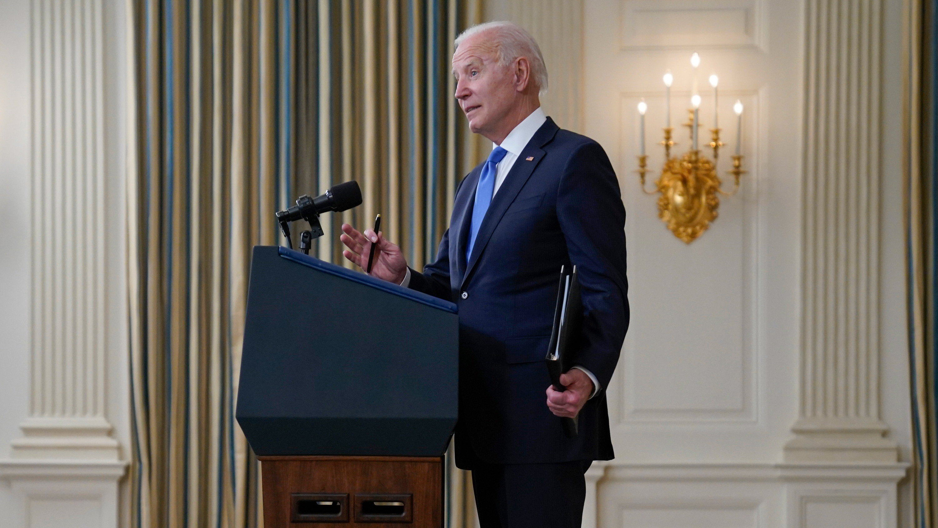 President Joe Biden takes questions from reporters as he speaks about the American Rescue Plan, in the State Dining Room of the White House on May 5 in Washington, DC.