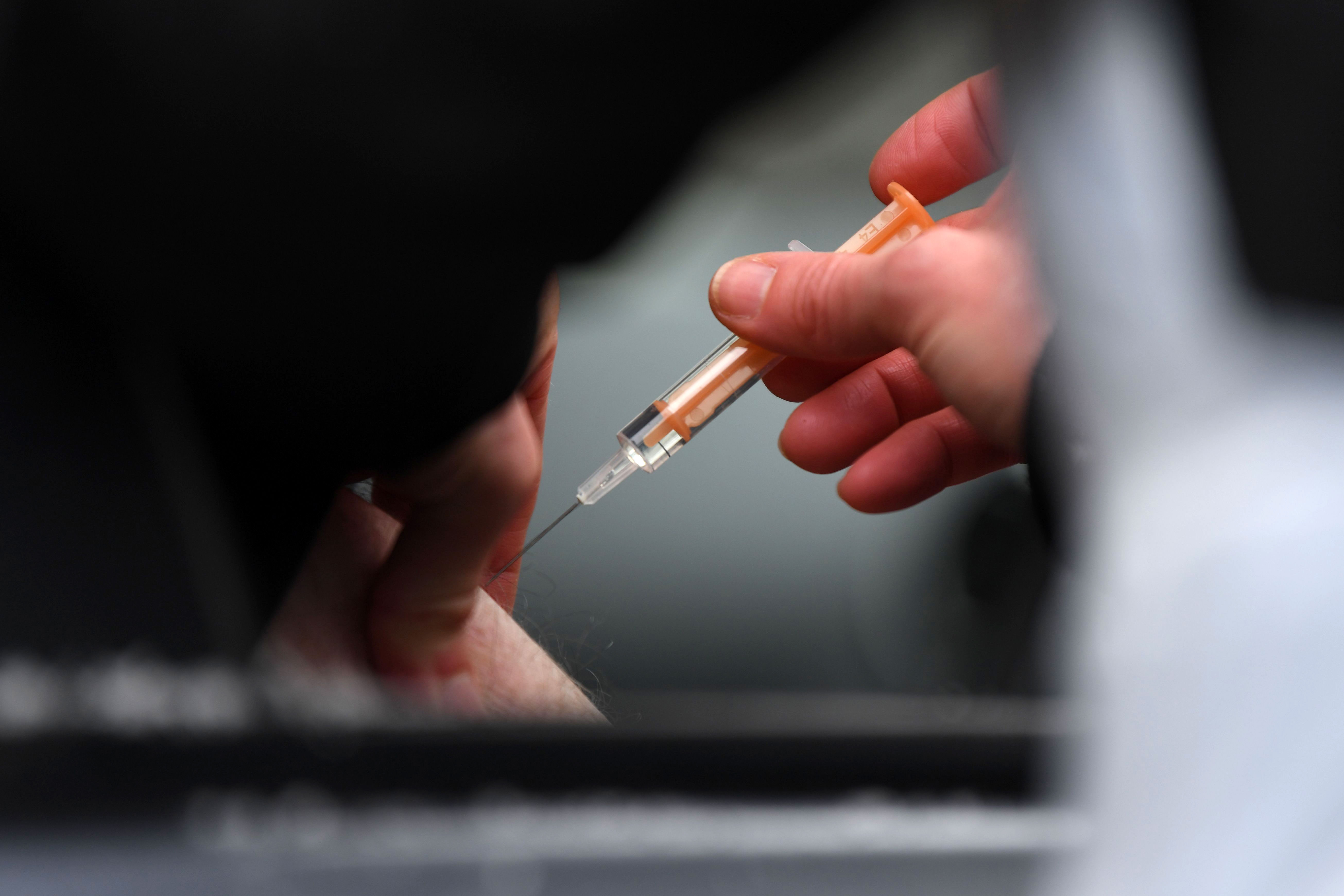 A health worker administers a Covid-19 vaccine in St Albans, England, on February 8.