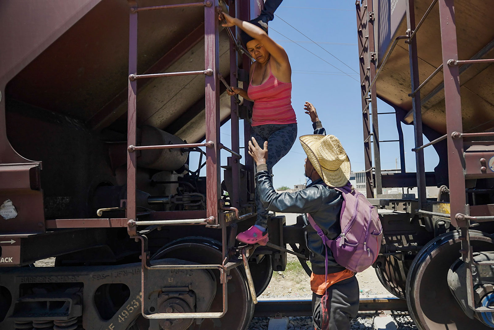 A woman is helped off a freight train after she became too scared to climb down from the roof on Sunday, May 7. Migrants have been traveling on top of freight trains as they headed north from southern Mexico. The woman's son, Leonardo Luzardo, told CNN it had been a long, cold night atop the train, feeling like their bodies were turning to ice. "It seemed like we were going to freeze," he said.
