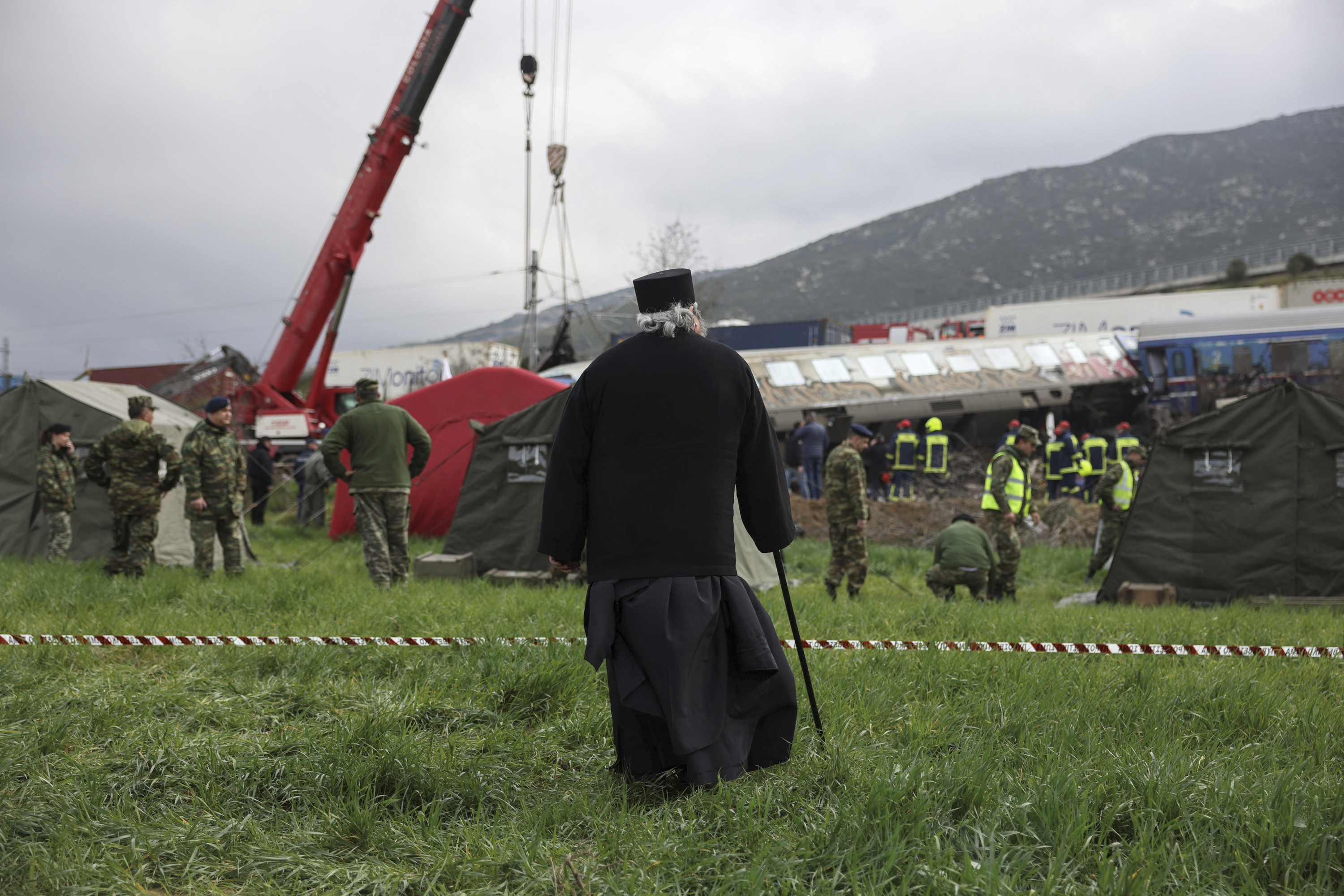 A Greek Orthodox priest is pictured at the site of the crash on Wednesday. 