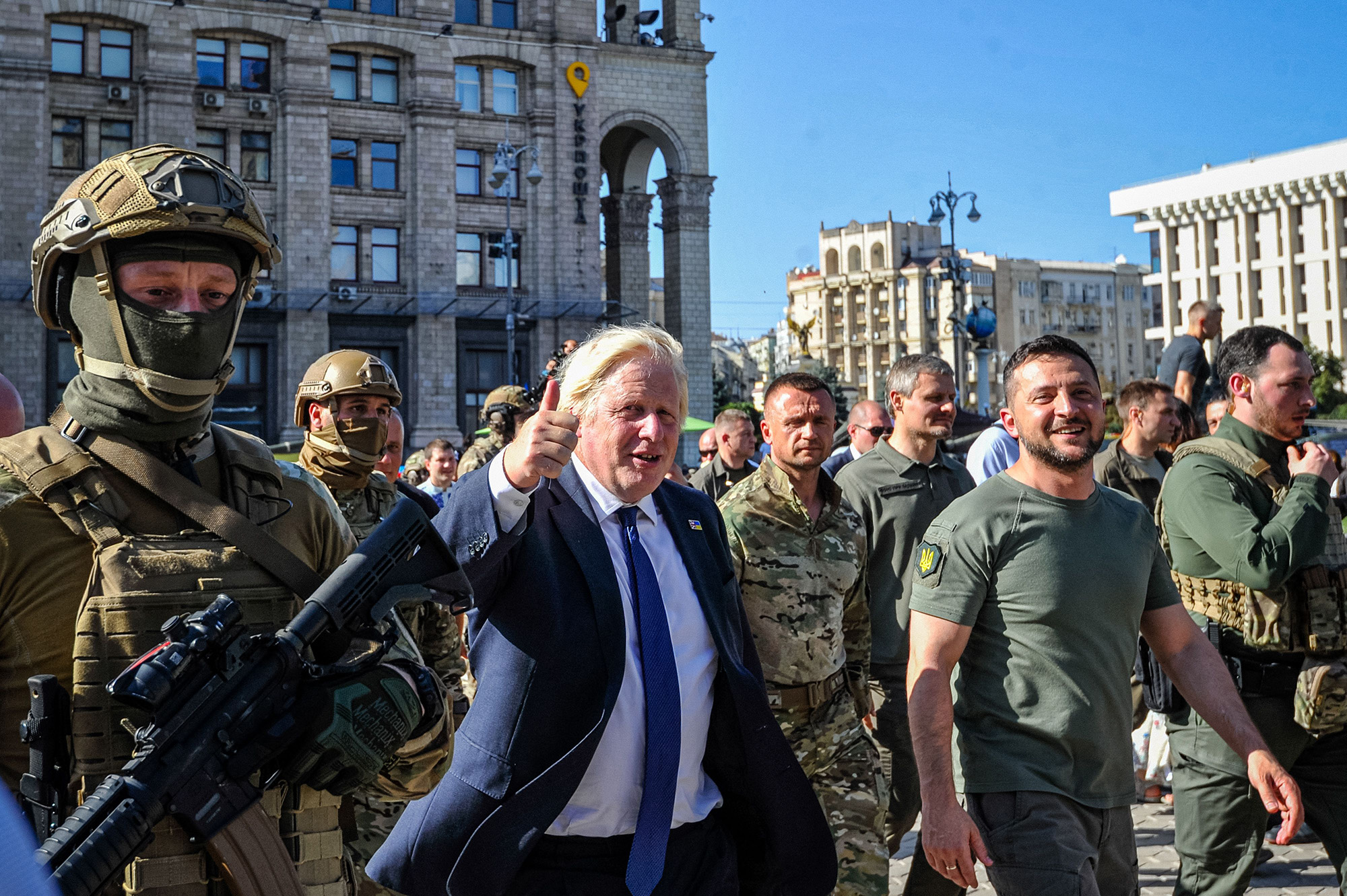 British Prime Minister Boris Johnson, center, and Ukrainian President Volodymyr Zelensky, right, walk at Kyiv's "Maidan" Independence Square on Ukraine's Independence Day on August 24.