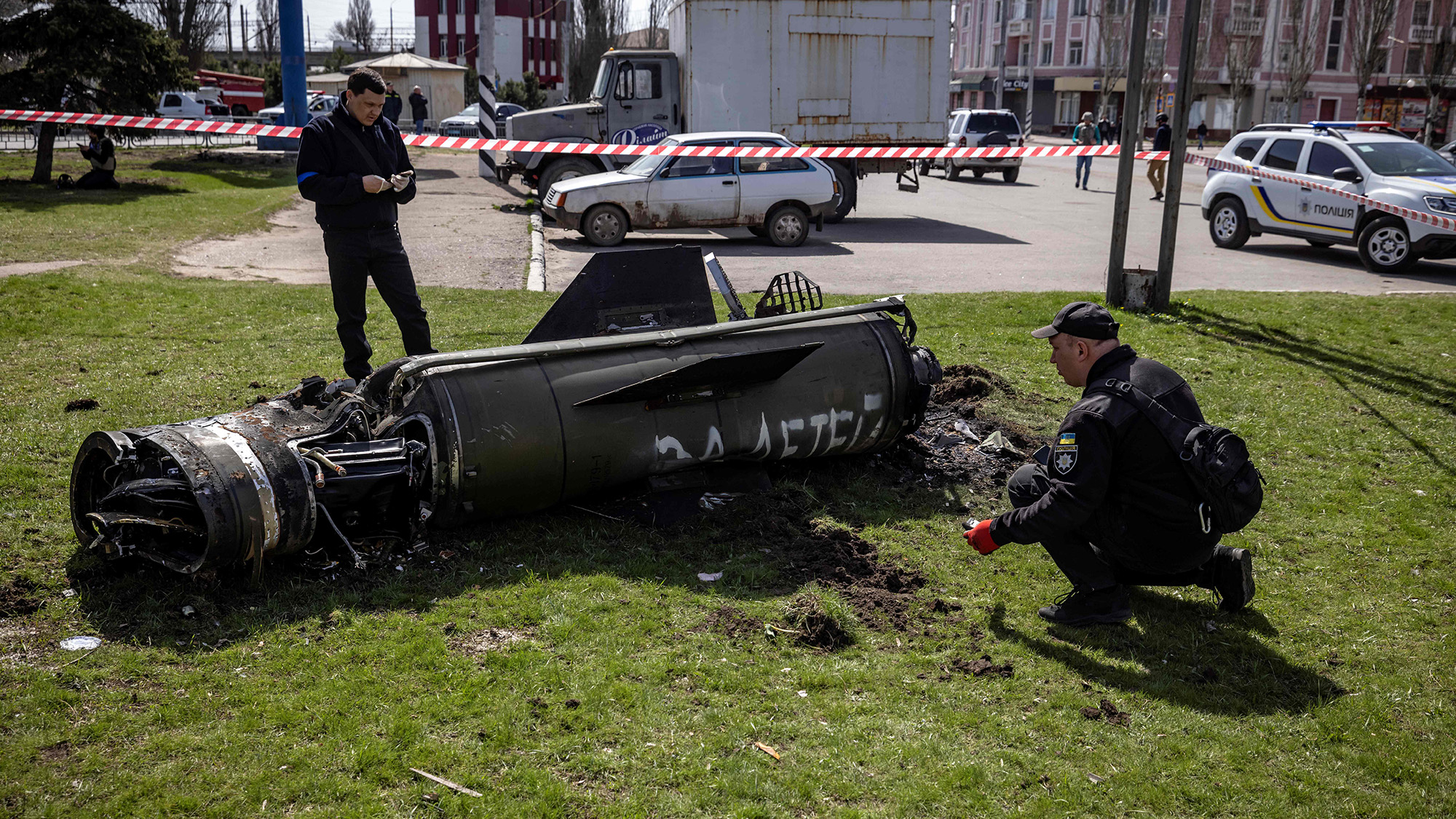 Ukrainian police inspect the remains of a large rocket next to the main building of a train station in Kramatorsk, Ukraine on April 8.