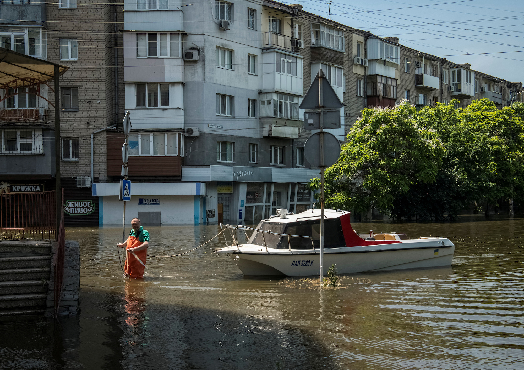 A man moors a boat at a flooded street during an evacuation in Kherson on Friday.