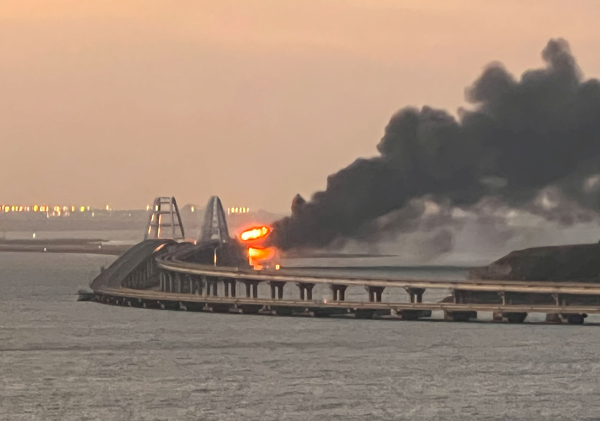 A fire burns on the Kerch bridge at sunrise in the Kerch Strait, Crimea on October 8.