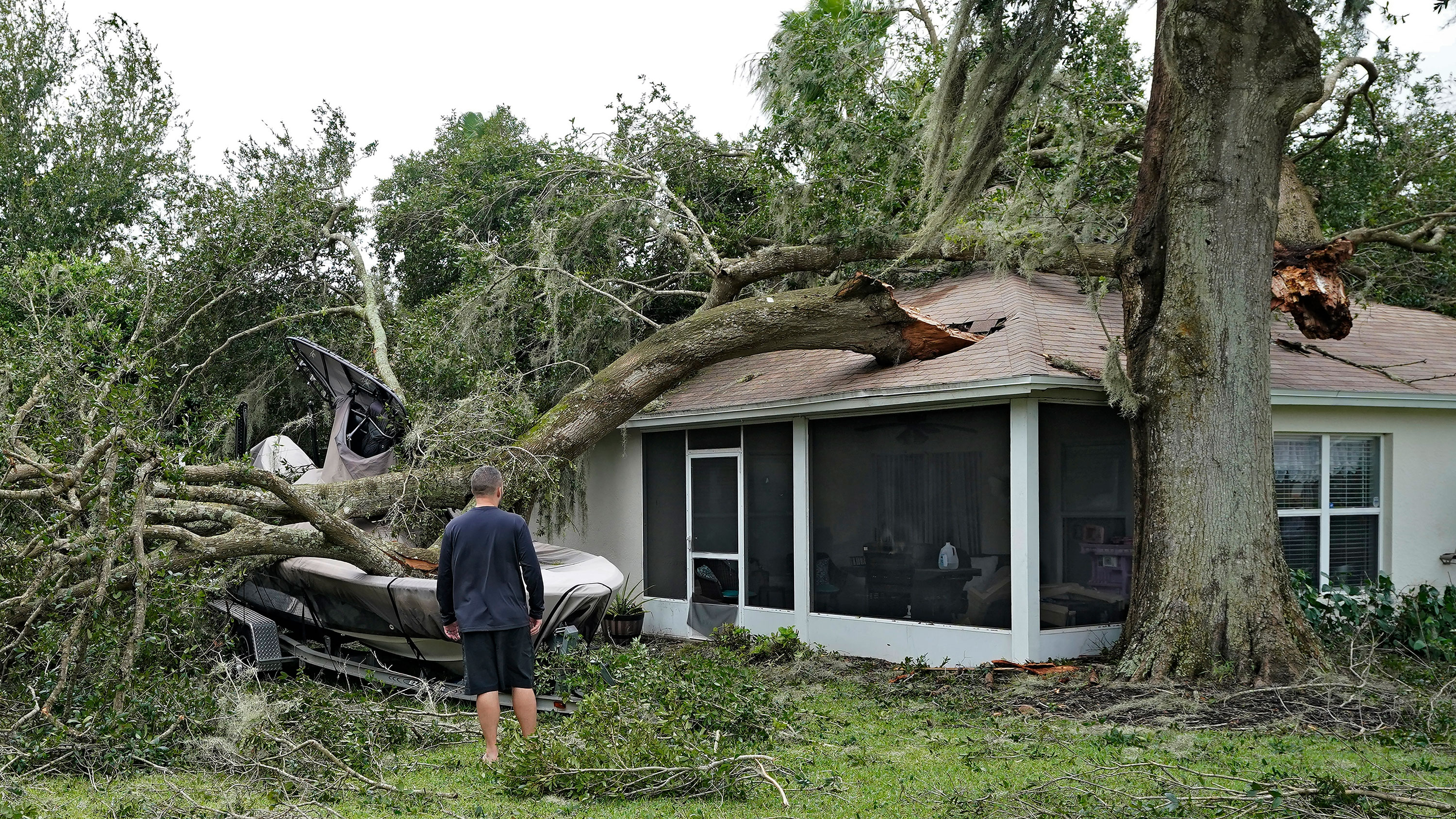 People survey damage to their home in Valrico, Florida.
