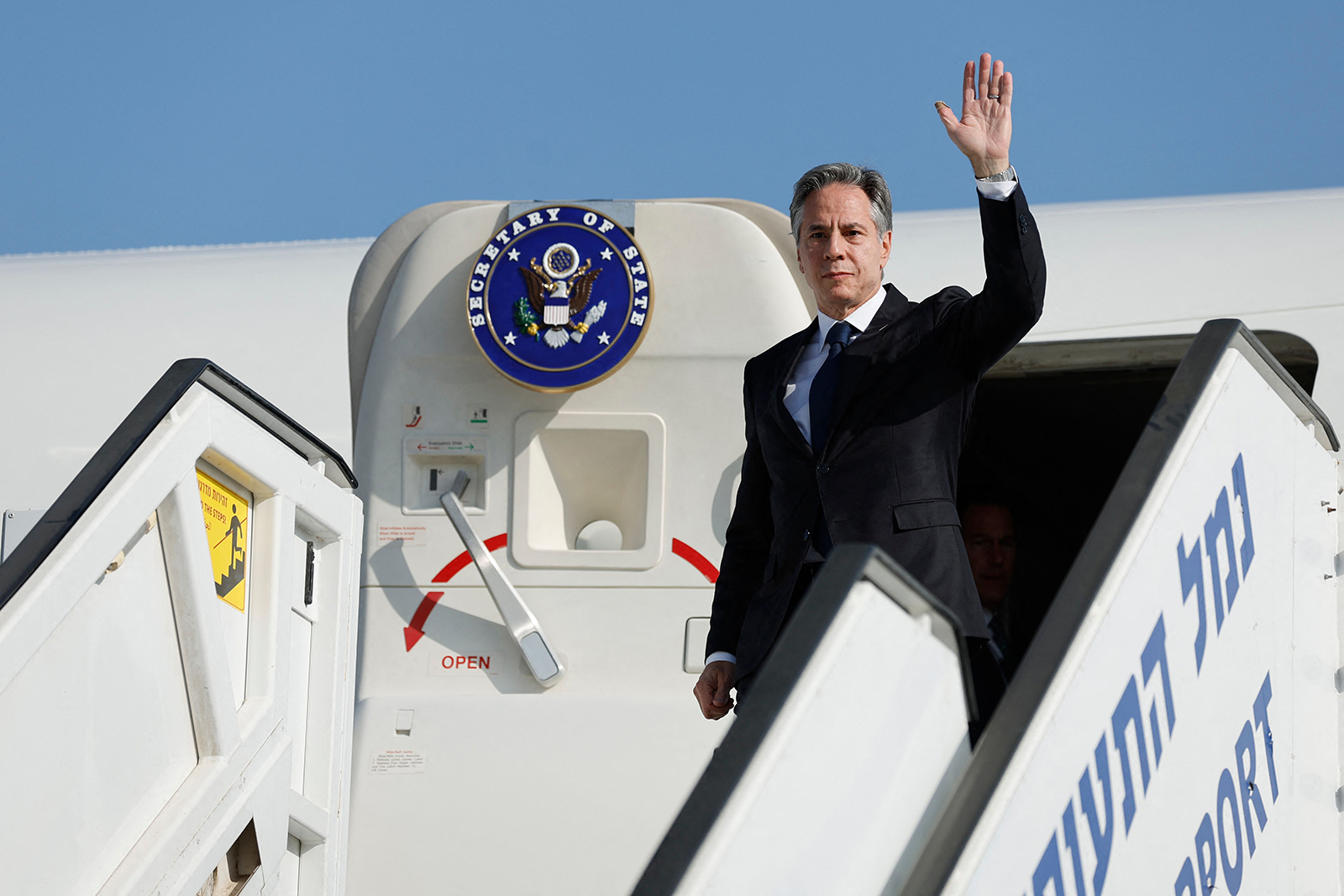 Antony Blinken waves as he disembarks from an aircraft for the start of his visit to Israel at Ben Gurion International airport near Tel Aviv on November 3.