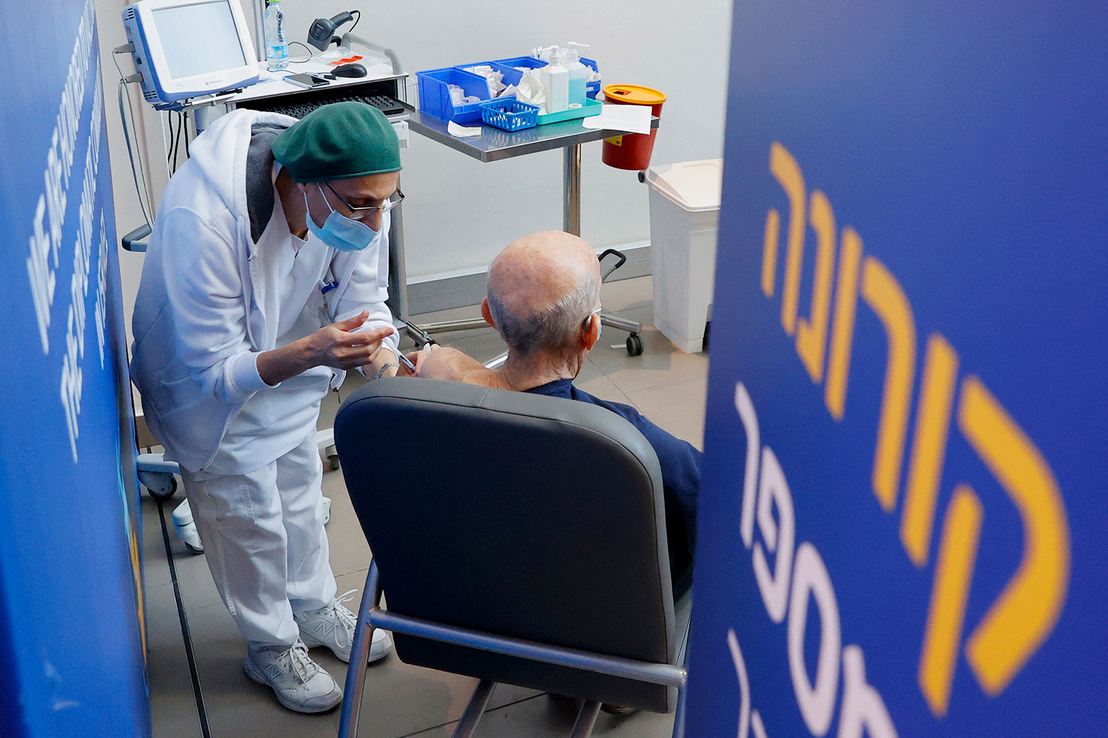 A person receives a fourth dose of the Pfizer-BioNTech COVID-19 coronavirus vaccine at Ichilov Tel Aviv Sourasky Medical Centre in Israel's Mediterranean coastal city of Tel Aviv on January 3.