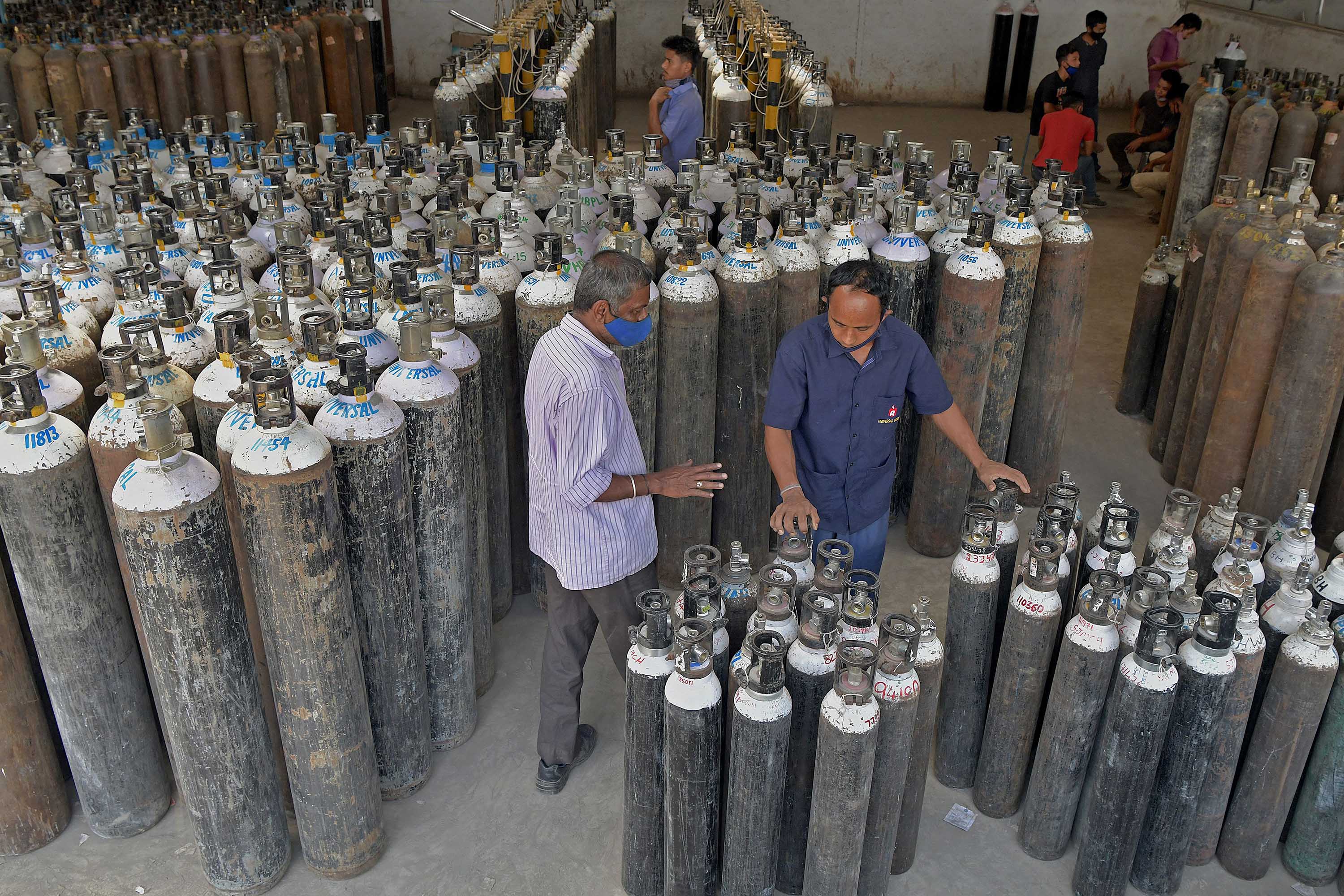 Workers are seen sorting oxygen cylinders for distribution to hospitals in Bangalore, India, on April 19, where they will be used to treat Covid-19 patients.