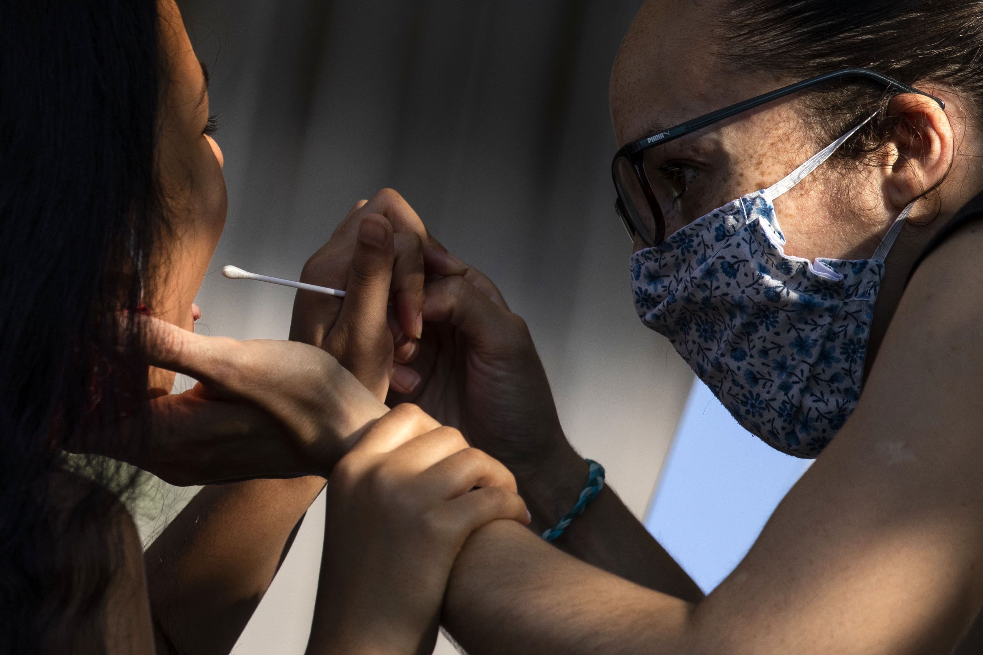 A woman administers a swab test at a Covid-19 testing site in London on September 15.