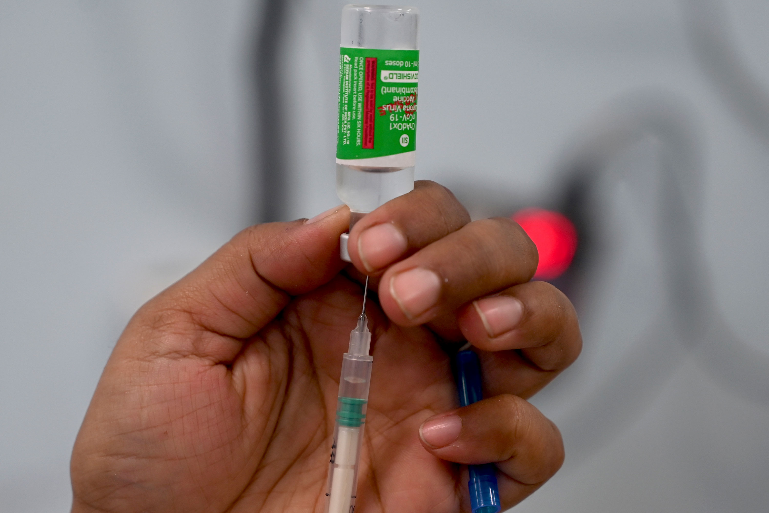 A person fills a syringe with AstraZeneca's Covishield vaccine in Mumbai, India, on March 17.