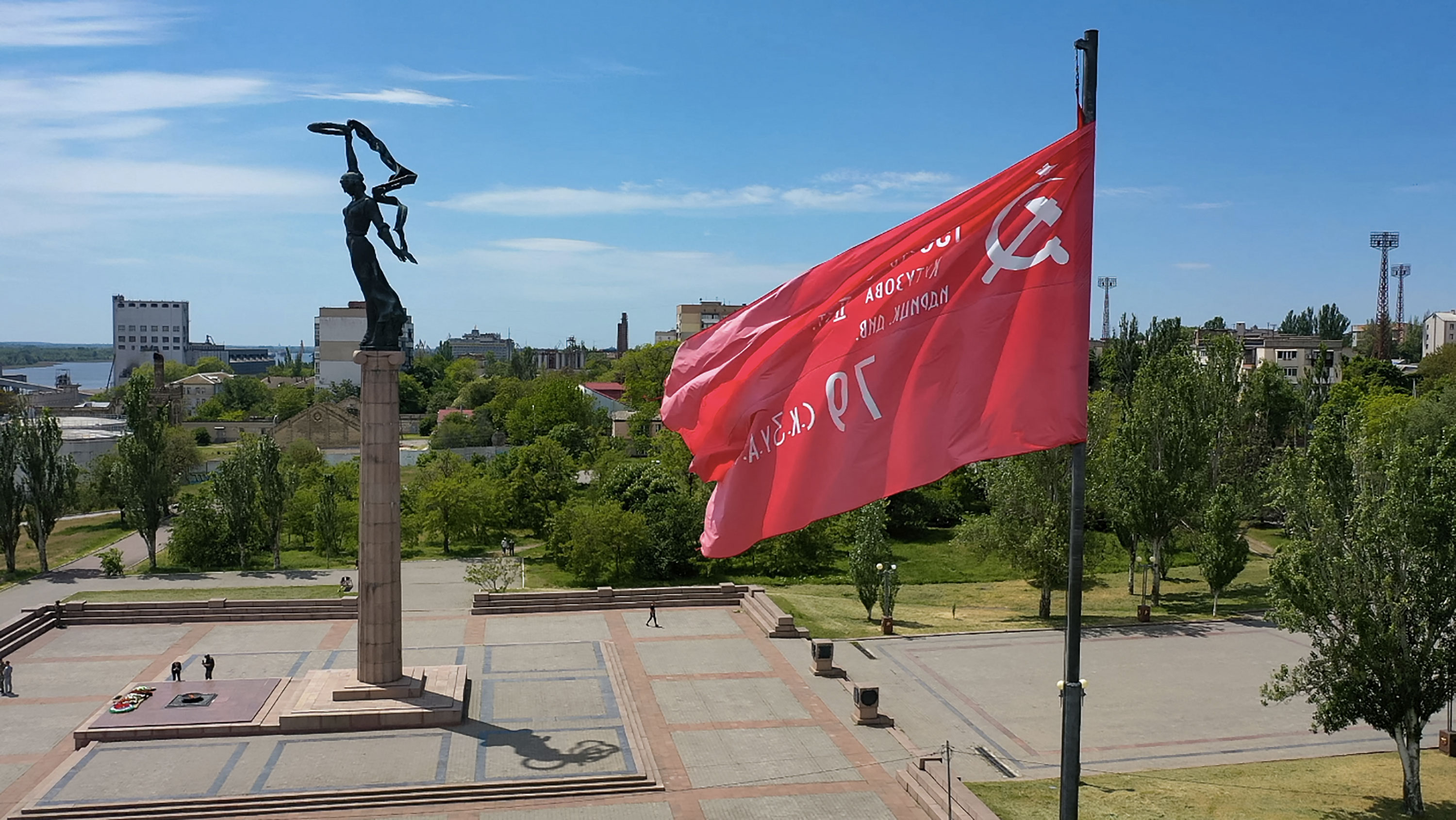 A replica of the Soviet Banner of Victory flies by a WWII memorial in Kherson, Ukraine, on May 20.