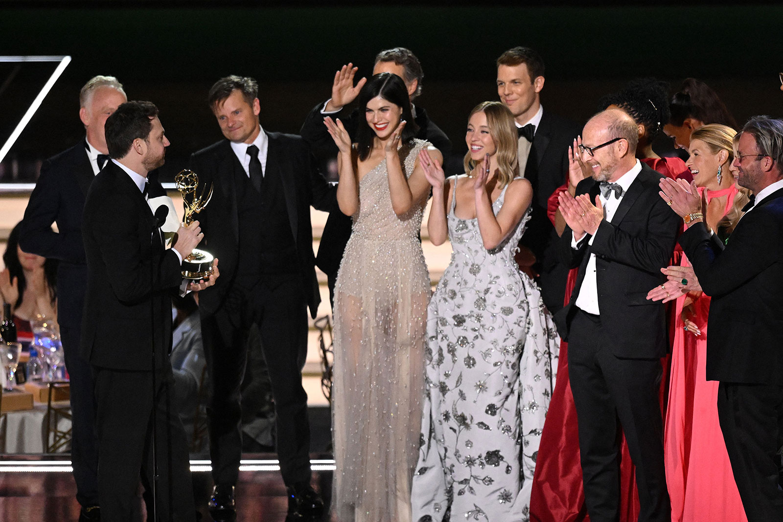 David Bernad, left, accepts the Emmy for outstanding limited or anthology series alongside cast and crew members of "White Lotus."