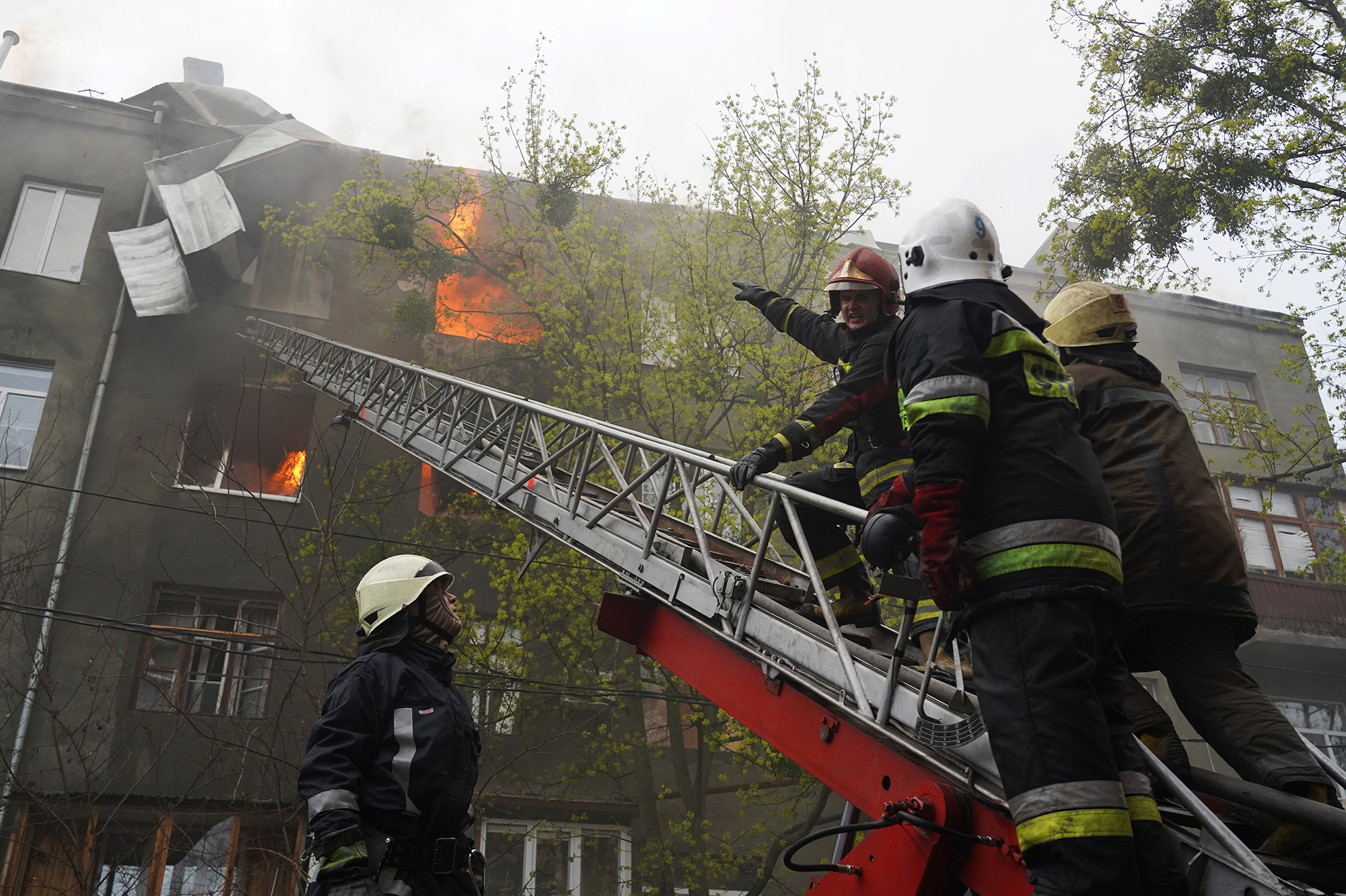 Firefighters work to extinguish fire at an apartment building after a Russian attack in Kharkiv, Ukraine on April 17. 