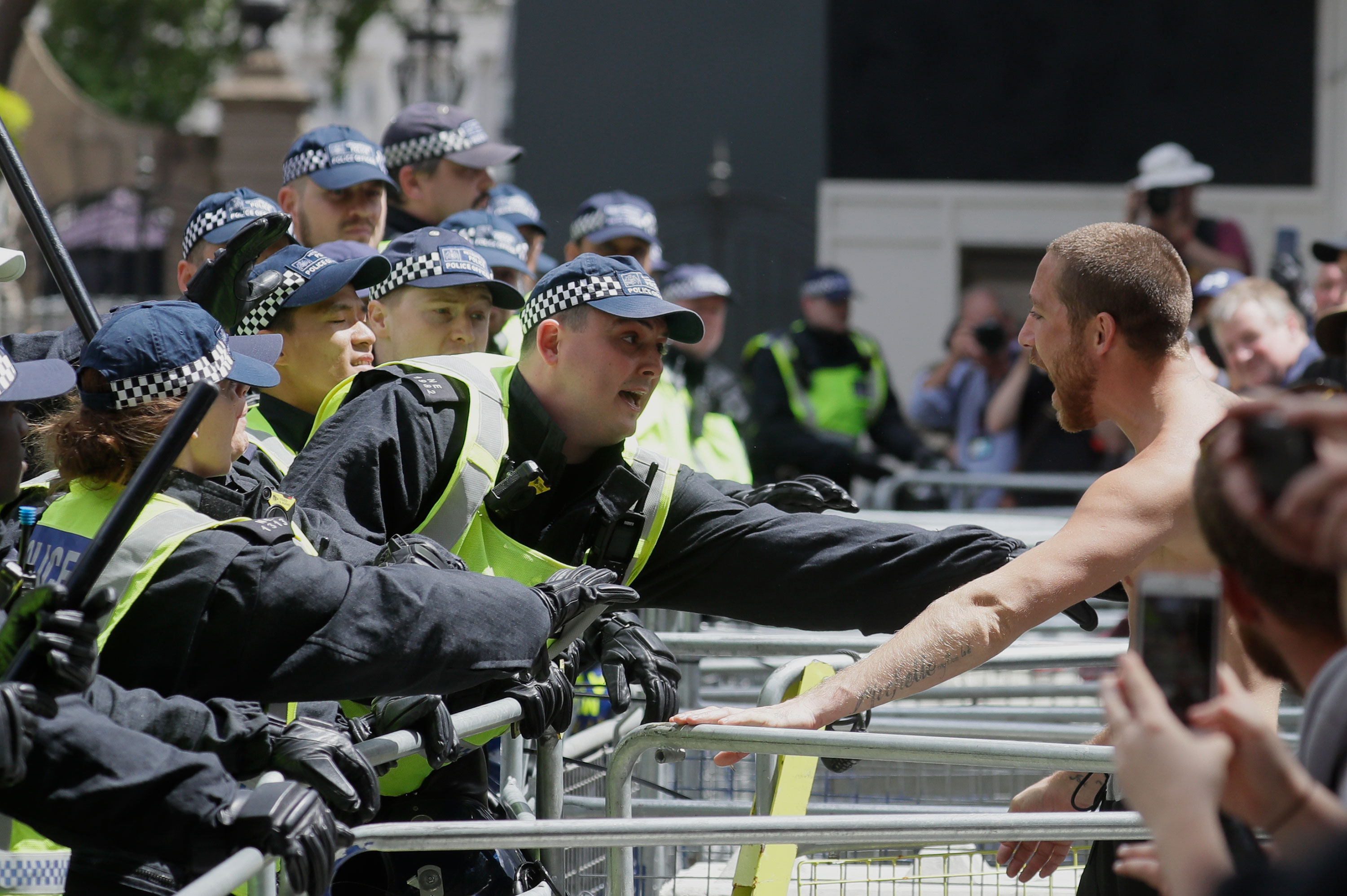 Police officers scuffle with members of far-right groups protesting in central London on Saturday, June 13.