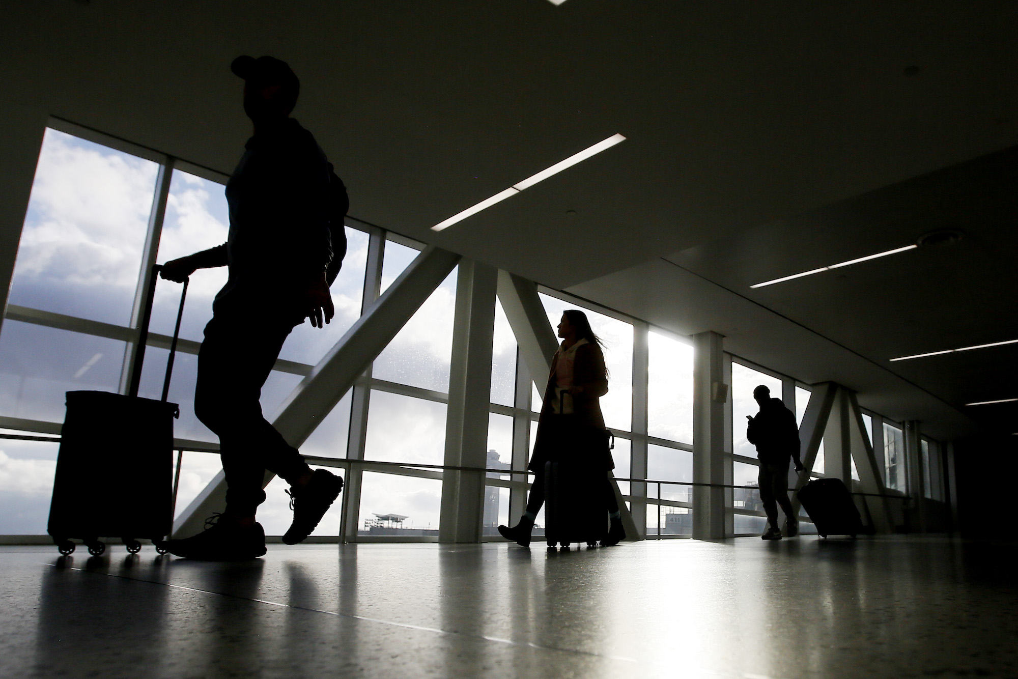Travelers walk through JFK Airport on Friday.
