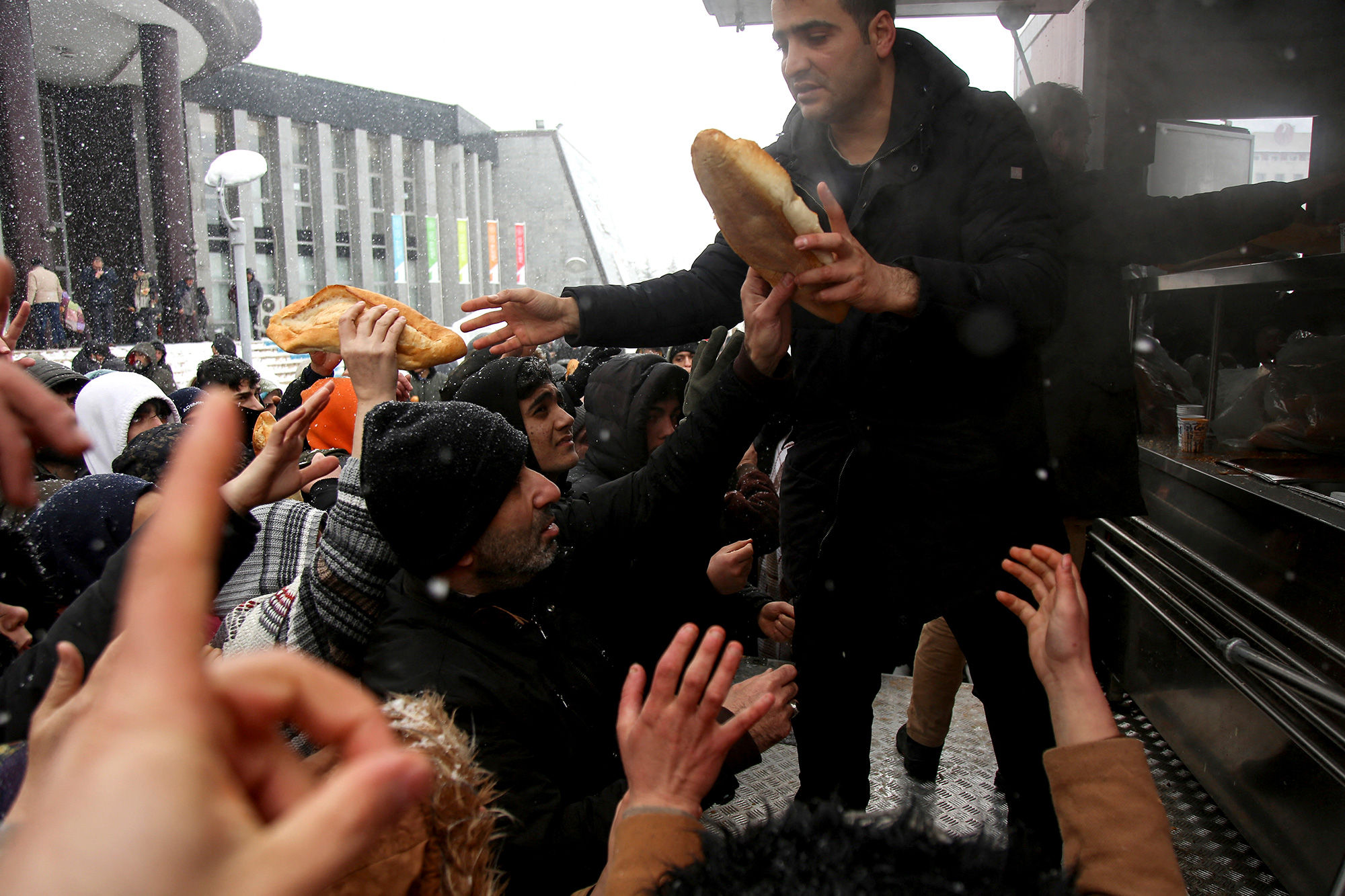 People hand out food to survivors in the Pazarcık district of Kahramanmaraş, Turkey.