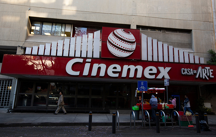 A street vendor sells candy outside a closed movie theater in Mexico City, Monday, March 23.