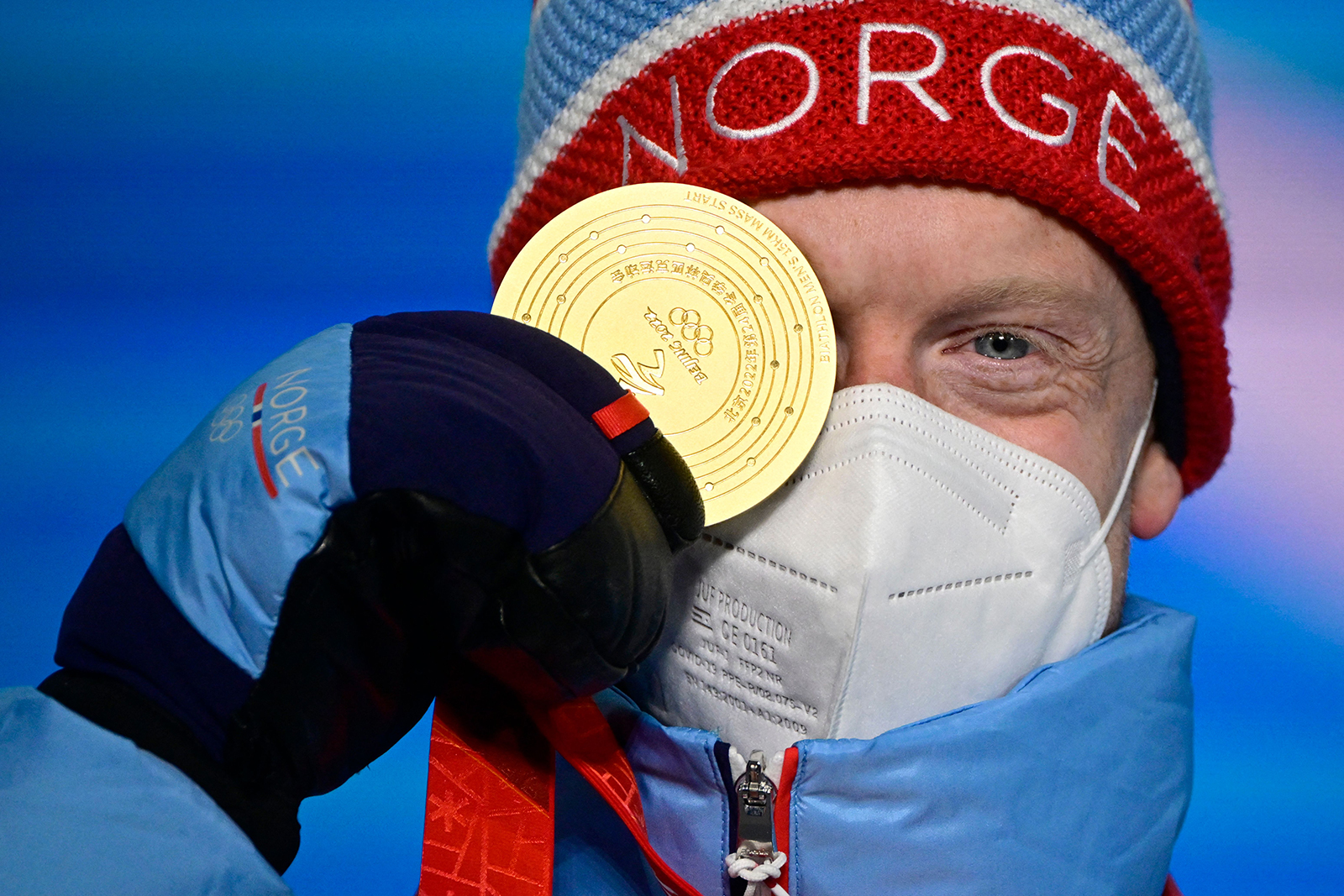 Gold medallist Norway's Johannes Thingnes Boe poses on the podium during the biathlon men's 15km mass start victory ceremony on February 19.